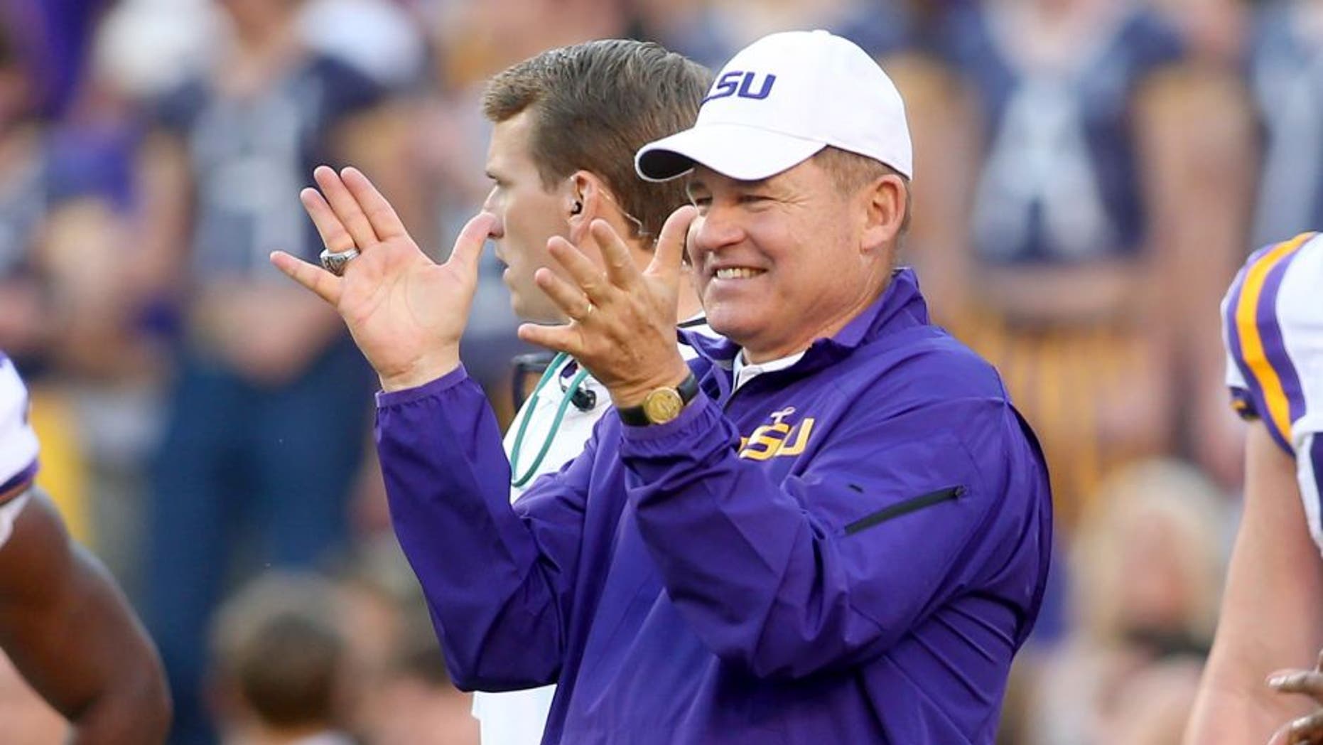 Oct 25, 2014; Baton Rouge, LA, USA; LSU Tigers head coach Les Miles claps for his team during pre game warm ups on the field prior to kickoff against the Mississippi Rebels at Tiger Stadium. LSU defeated Mississippi 10-7. Mandatory Credit: Crystal LoGiudice-USA TODAY Sports