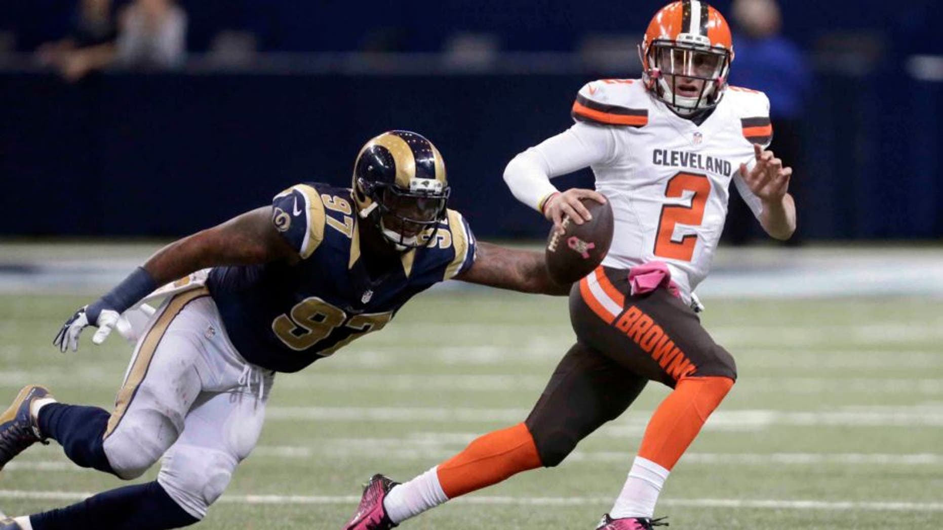 Cleveland Browns quarterback Johnny Manziel, right, runs with the ball as St. Louis Rams defensive end Eugene Sims pursues during the fourth quarter of an NFL football game Sunday, Oct. 25, 2015, in St. Louis. The Rams won 24-6. (AP Photo/Tom Gannam)