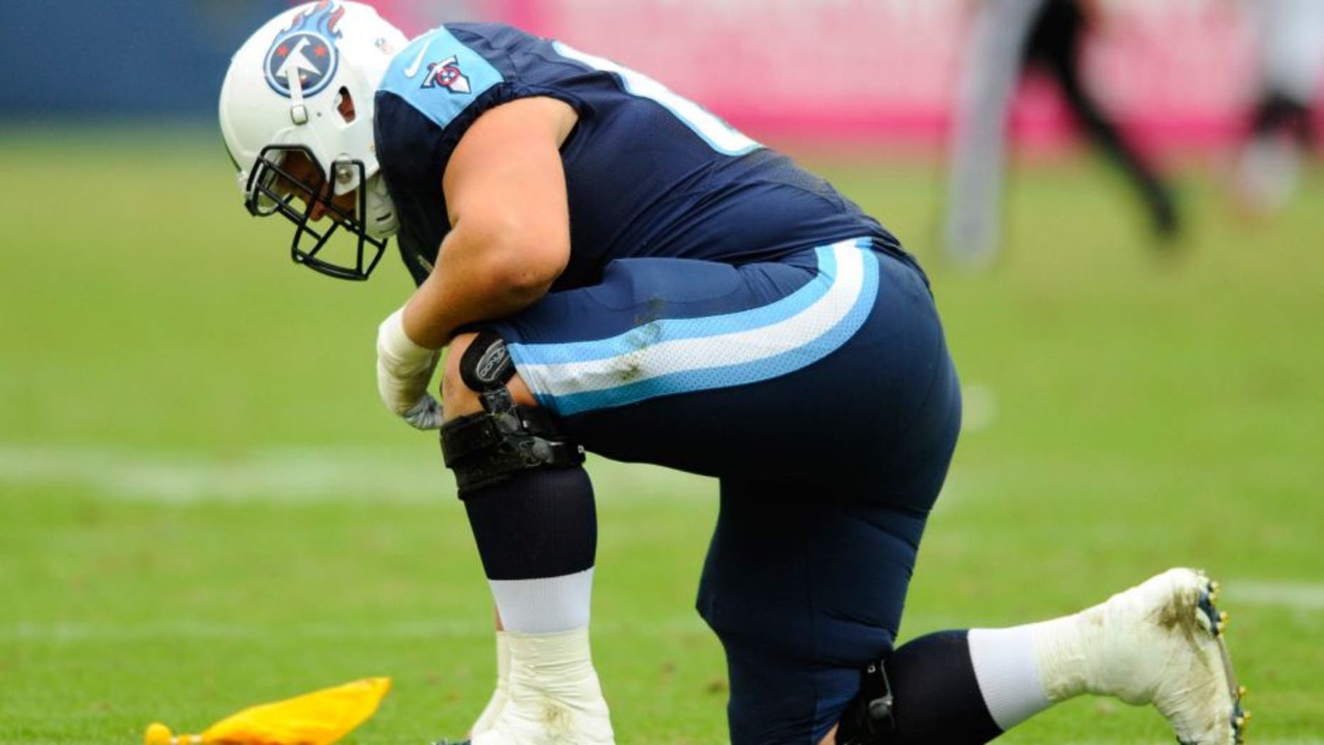 Oct 25, 2015; Nashville, TN, USA; Tennessee Titans center Andy Gallik (69) is slow to get up after being illegally hit following an interception by Atlanta Falcons linebacker Paul Worrilow (not pictured)during the first half at Nissan Stadium. Mandatory Credit: Christopher Hanewinckel-USA TODAY Sports