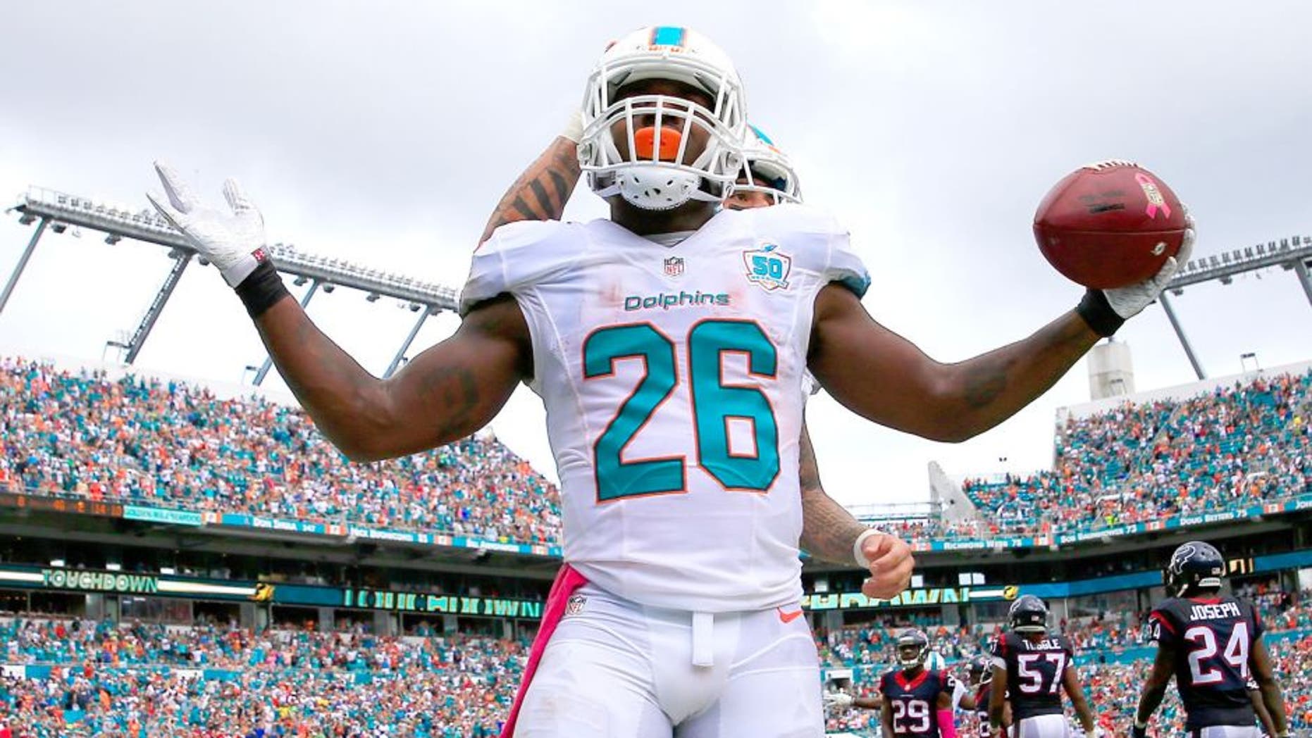 MIAMI GARDENS, FL - OCTOBER 25: Lamar Miller #26 of the Miami Dolphins celebrates his touchdown in the second quarter against the Houston Texans at Sun Life Stadium on October 25, 2015 in Miami Gardens, Florida. (Photo by Chris Trotman/Getty Images)