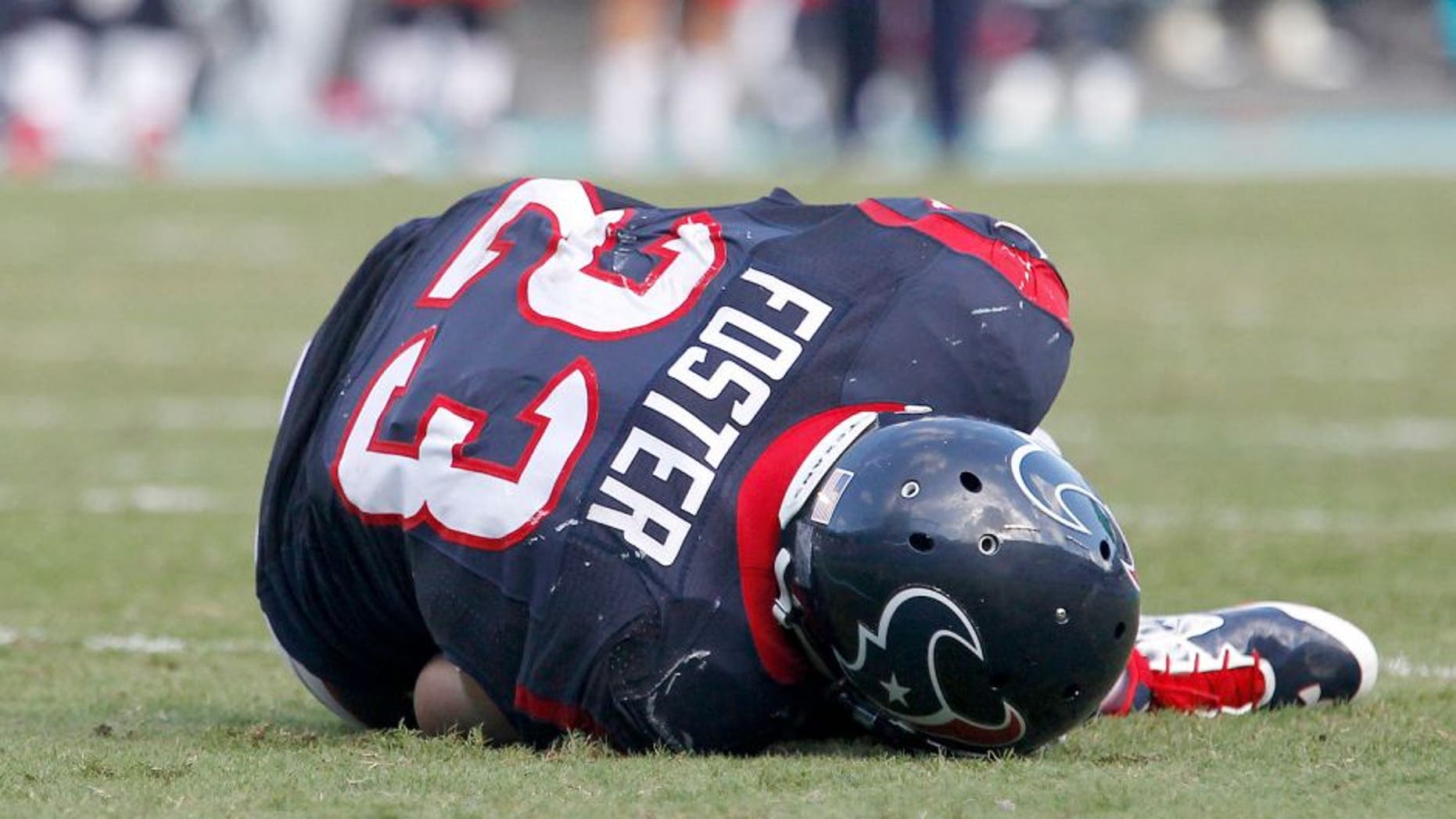 Oct 25, 2015; Miami Gardens, FL, USA; Houston Texans running back Arian Foster (23) lays on the ground after being injured in the fourth quarter against the Miami Dolphins at Sun Life Stadium. The Dolphins won 44-26. Mandatory Credit: Andrew Innerarity-USA TODAY Sports