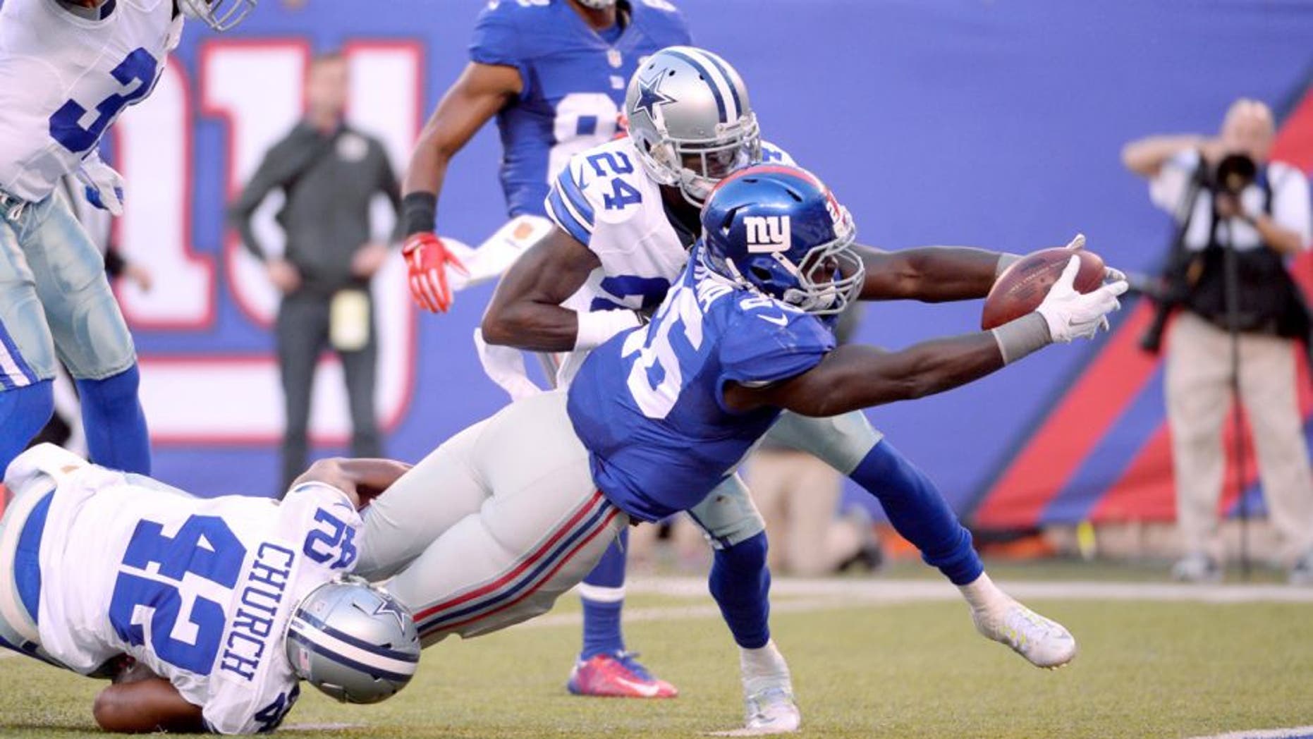 Oct 25, 2015; East Rutherford, NJ, USA; New York Giants running back Orleans Darkwa (26) dives for a touchdown pas Dallas Cowboys strong safety Barry Church (42) in the first half during the NFL game at MetLife Stadium. Mandatory Credit: Robert Deutsch-USA TODAY Sports