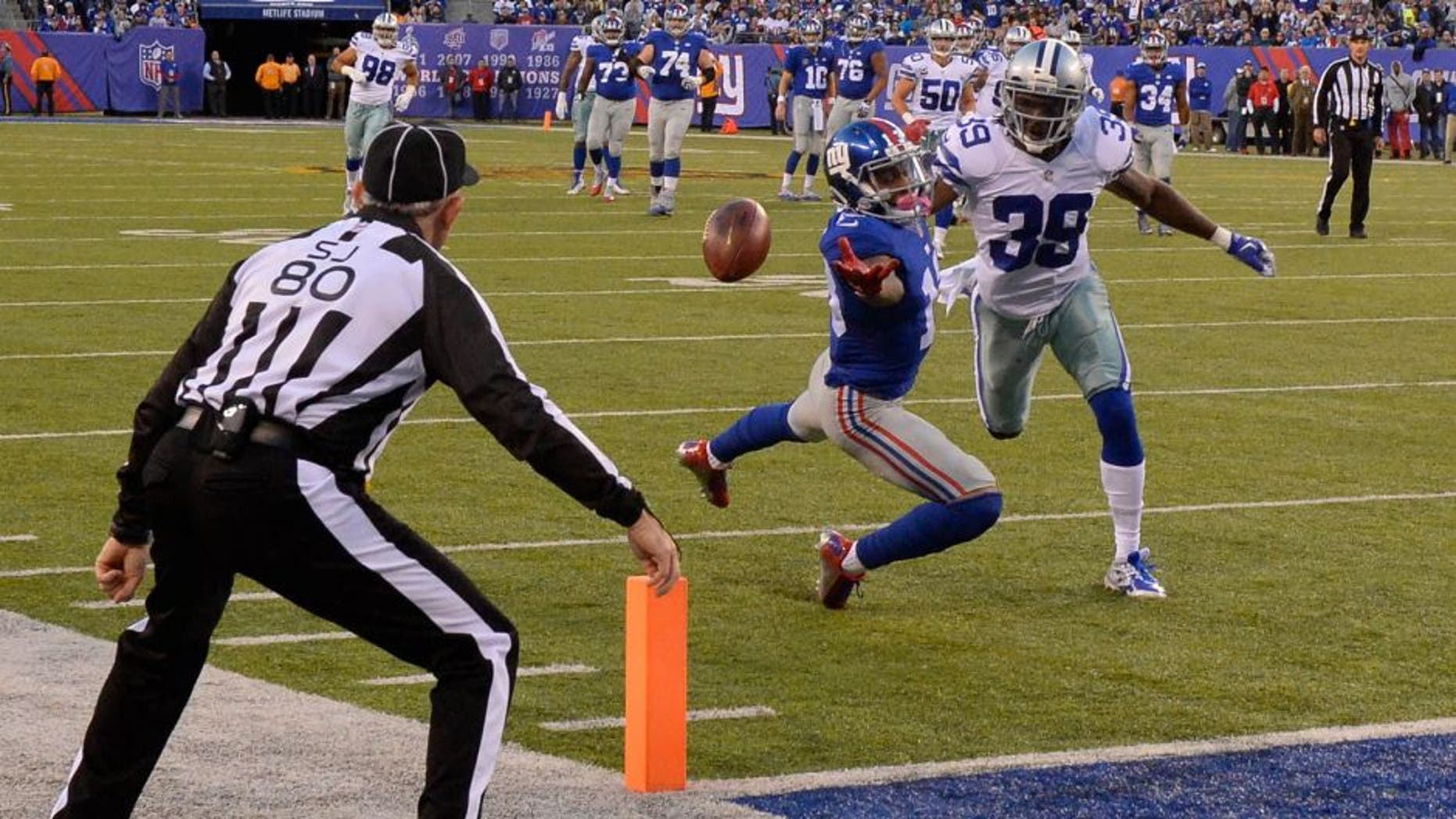 Oct 25, 2015; East Rutherford, NJ, USA; New York Giants wide receiver Odell Beckham (13) cannot catch a pass while defended by Dallas Cowboys strong safety Jeff Heath (38) in the first half during the NFL game at MetLife Stadium. Mandatory Credit: Robert Deutsch-USA TODAY Sports