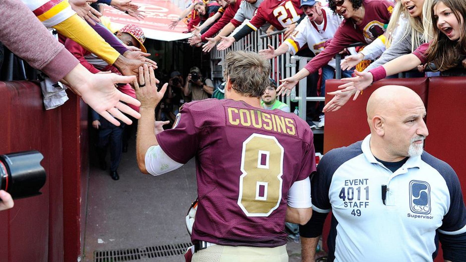 Oct 25, 2015; Landover, MD, USA; Washington Redskins quarterback Kirk Cousins (8) is congratulated by fans after the game between the Washington Redskins and the Tampa Bay Buccaneers at FedEx Field. The Washington Redskins won 31 - 30. Mandatory Credit: Brad Mills-USA TODAY Sports