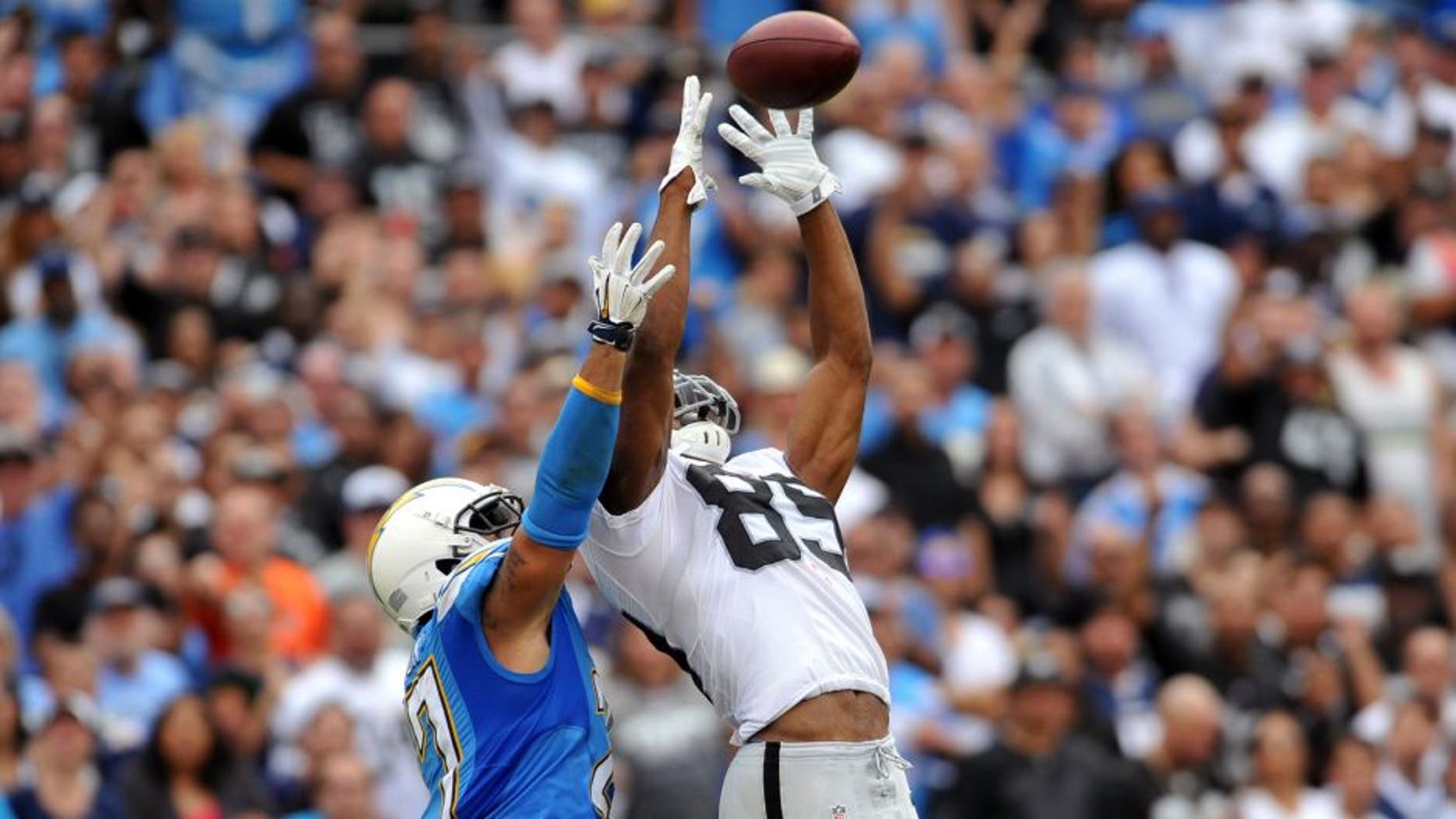 Oct 25, 2015; San Diego, CA, USA; Oakland Raiders wide receiver Amari Cooper (89) catches a pass while defended by San Diego Chargers defensive back Jimmy Wilson (27) during the second quarter at Qualcomm Stadium. Mandatory Credit: Orlando Ramirez-USA TODAY Sports