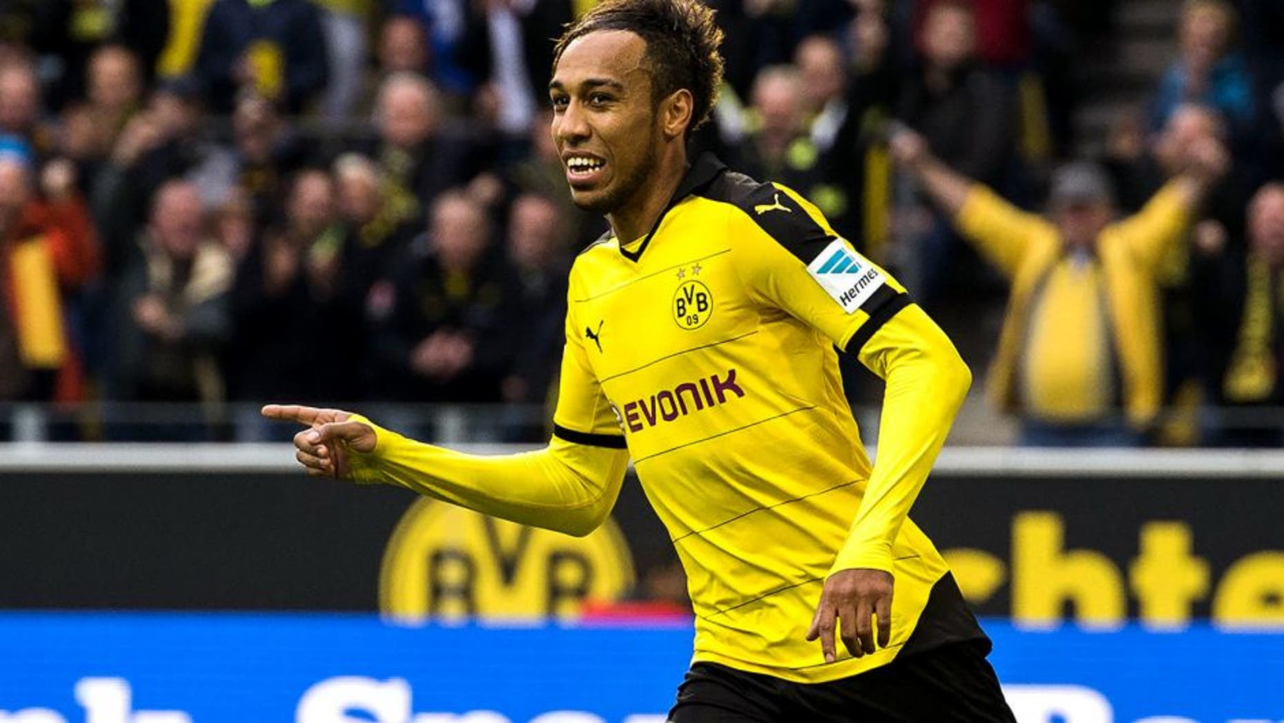 Dortmund's Gabonese midfielder Pierre-Emerick Aubameyang (R) celebrates scoring the opening goal during the German first division football Bundesliga match between Borussia Dortmund and FC Augsburg on October 25, 2015 in Dortmund, western Germany. AFP PHOTO / ODD ANDERSEN RESTRICTIONS: DURING MATCH TIME: DFL RULES TO LIMIT THE ONLINE USAGE TO 15 PICTURES PER MATCH AND FORBID IMAGE SEQUENCES TO SIMULATE VIDEO. ==RESTRICTED TO EDITORIAL USE == FOR FURTHER QUERIES PLEASE CONTACT THE DFL DIRECTLY AT + 49 69 650050. (Photo credit should read ODD ANDERSEN/AFP/Getty Images)