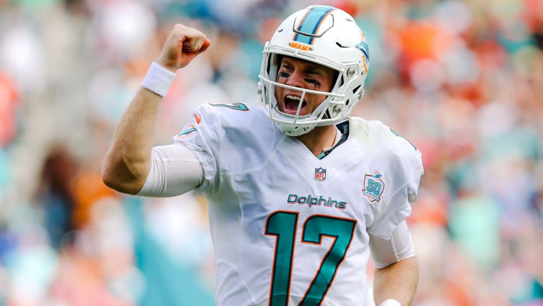 Oct 25, 2015; Miami Gardens, FL, USA; Miami Dolphins quarterback Ryan Tannehill (17) celebrates after running back Lamar Miller (not pictured) scors a touchdown against the Houston Texans during the first half at Sun Life Stadium. Mandatory Credit: Steve Mitchell-USA TODAY Sports