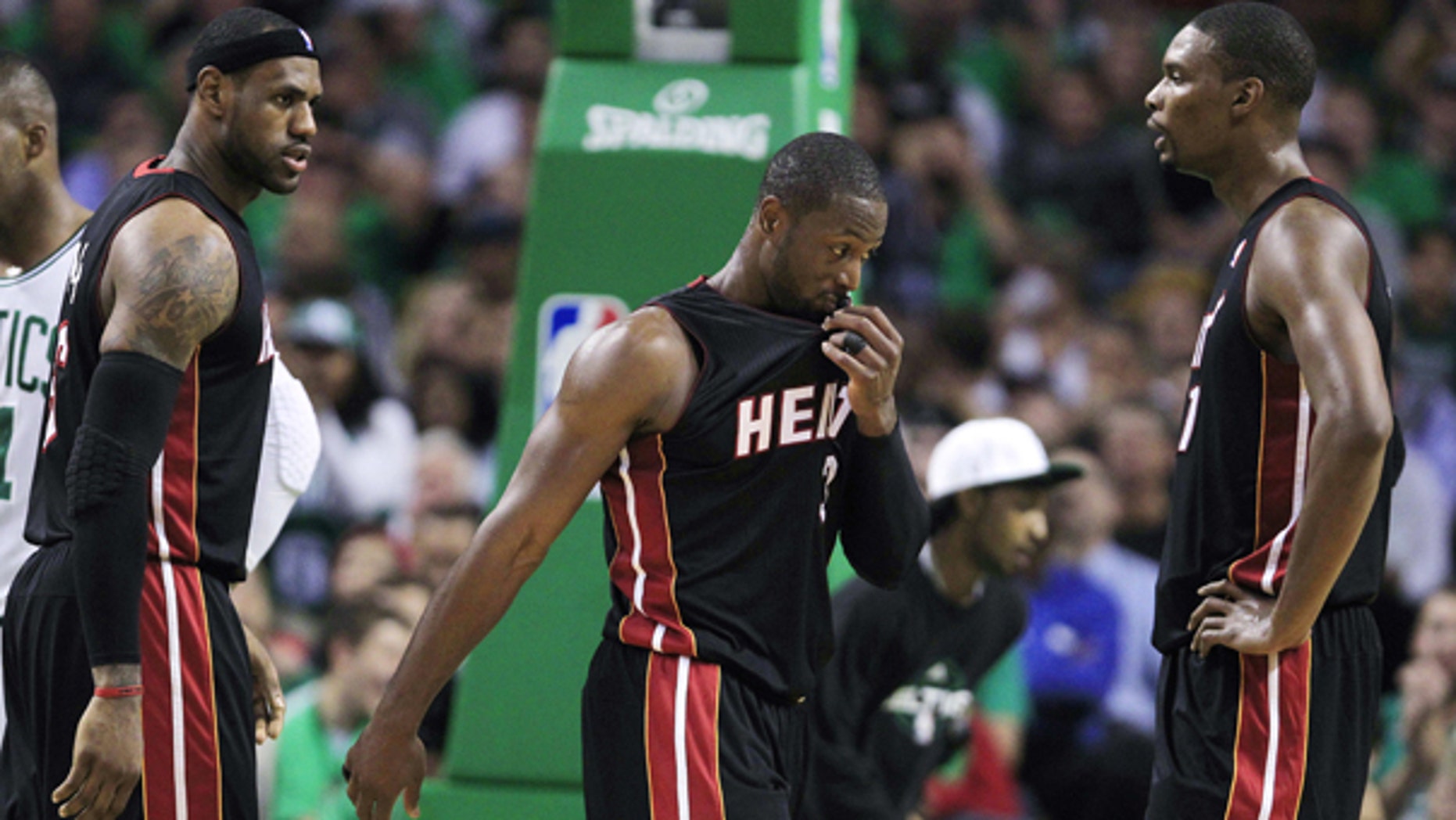 Oct. 26: Miami Heat forward LeBron James, left, talks with teammates Dwyane Wade, center, and Chris Bosh, right, while trailing the Boston Celtics during the first half of an NBA basketball game in Boston.