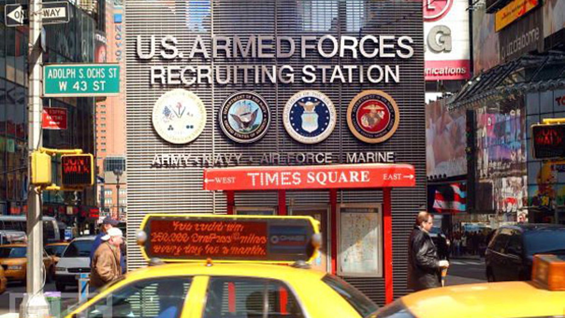 Taxis and pedestrians pass by the Times Square U.S. Armed Forces Recruiting Station.