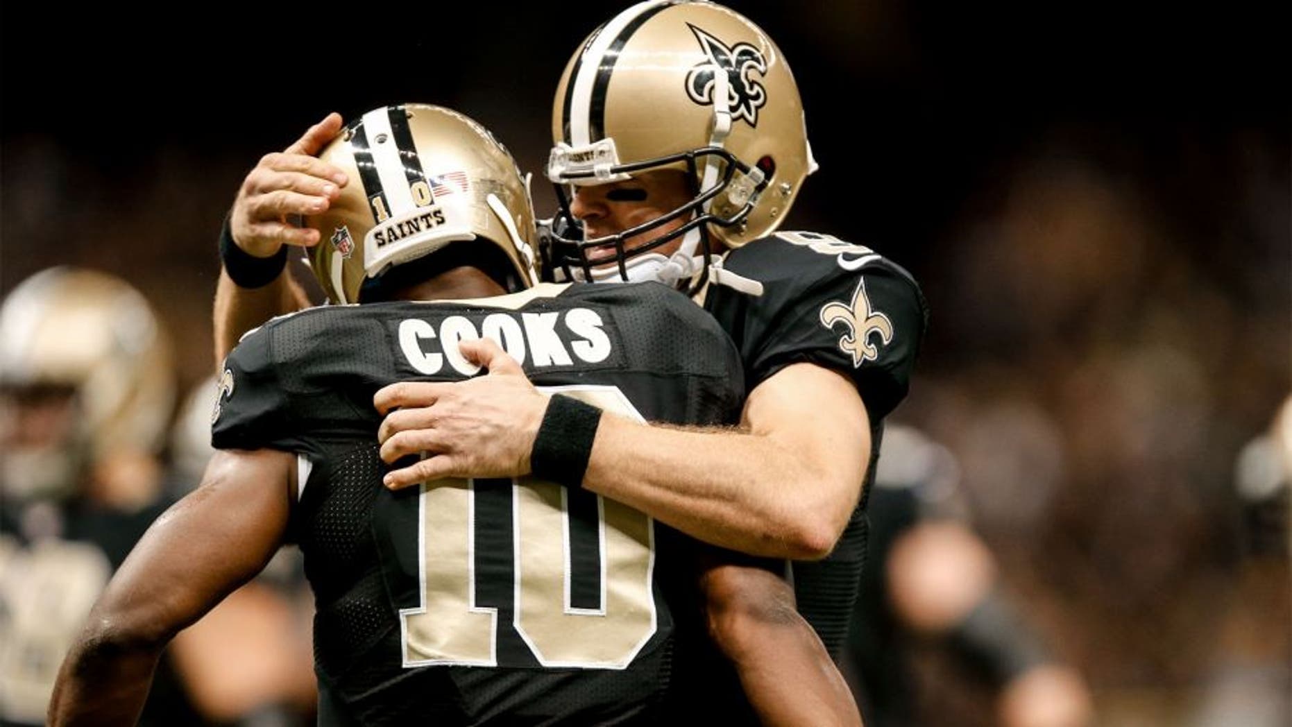 Oct 26, 2014; New Orleans, LA, USA; New Orleans Saints quarterback Drew Brees (9) celebrates with wide receiver Brandin Cooks (10) after a touchdown during the third quarter of a game against the Green Bay Packers at the Mercedes-Benz Superdome. Mandatory Credit: Derick E. Hingle-USA TODAY Sports