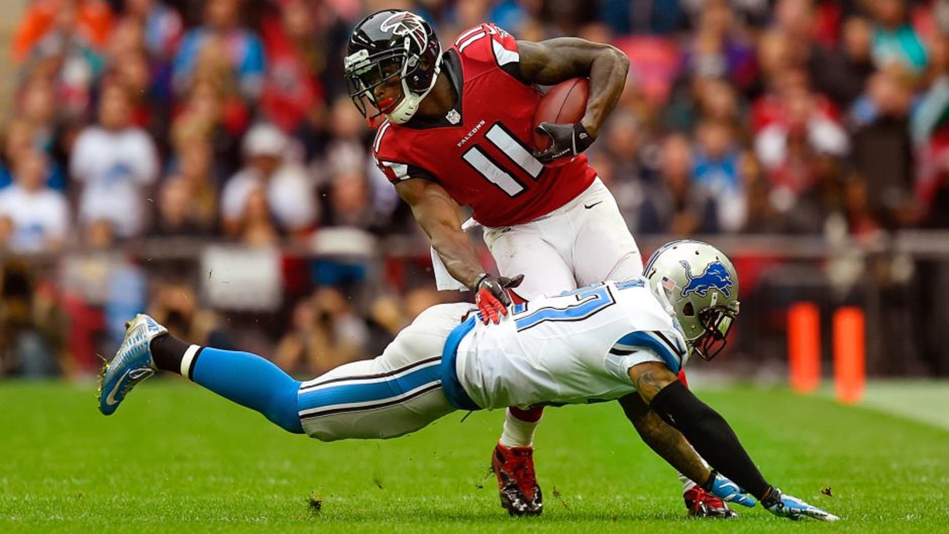 LONDON, ENGLAND - OCTOBER 26: Julio Jones #11 of the Atlanta Falcons evades the tackle from Glover Quin #27 of the Detroit Lions during the NFL match between Detroit Lions and Atlanta Falcons at Wembley Stadium on October 26, 2014 in London, England. (Photo by Mike Hewitt/Getty Images)