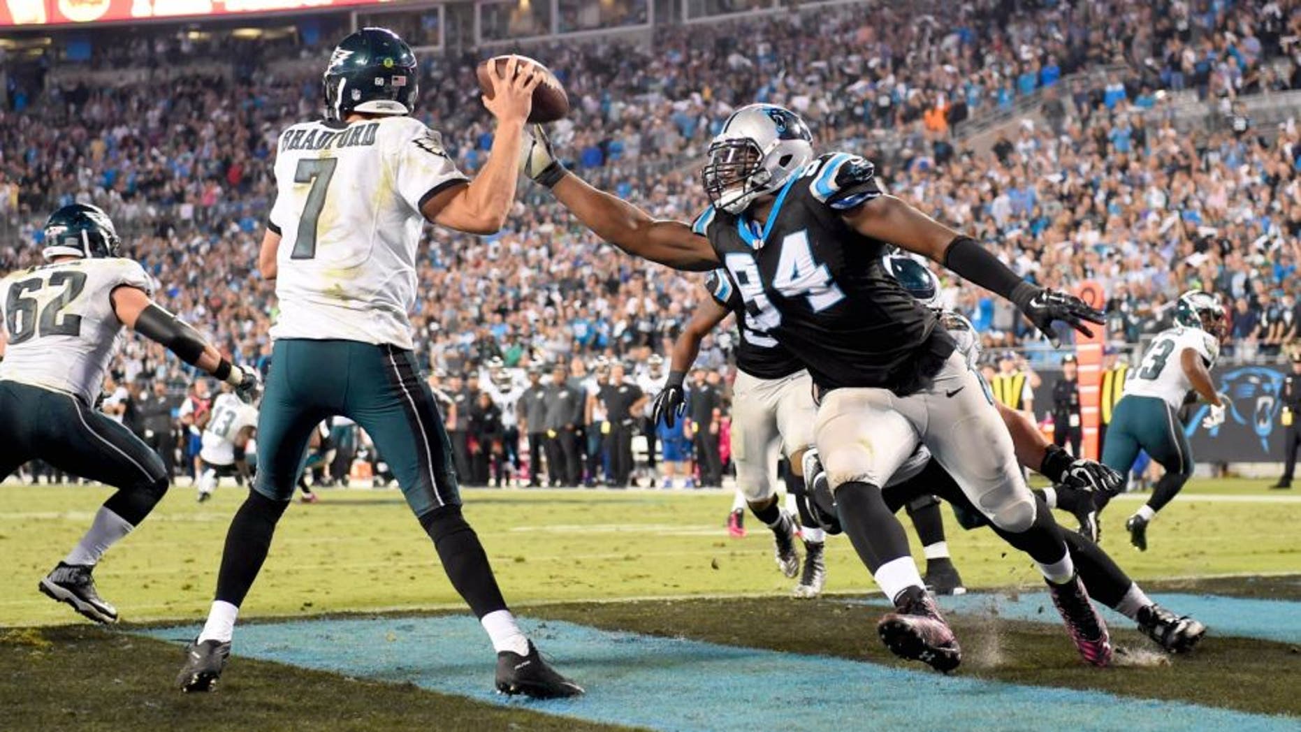 Oct 25, 2015; Charlotte, NC, USA; Philadelphia Eagles quarterback Sam Bradford (7) looks to pass as Carolina Panthers defensive end Kony Ealy (94) pressures in the fourth quarter. The Panthers defeated the Falcons 27-16 at Bank of America Stadium. Mandatory Credit: Bob Donnan-USA TODAY Sports
