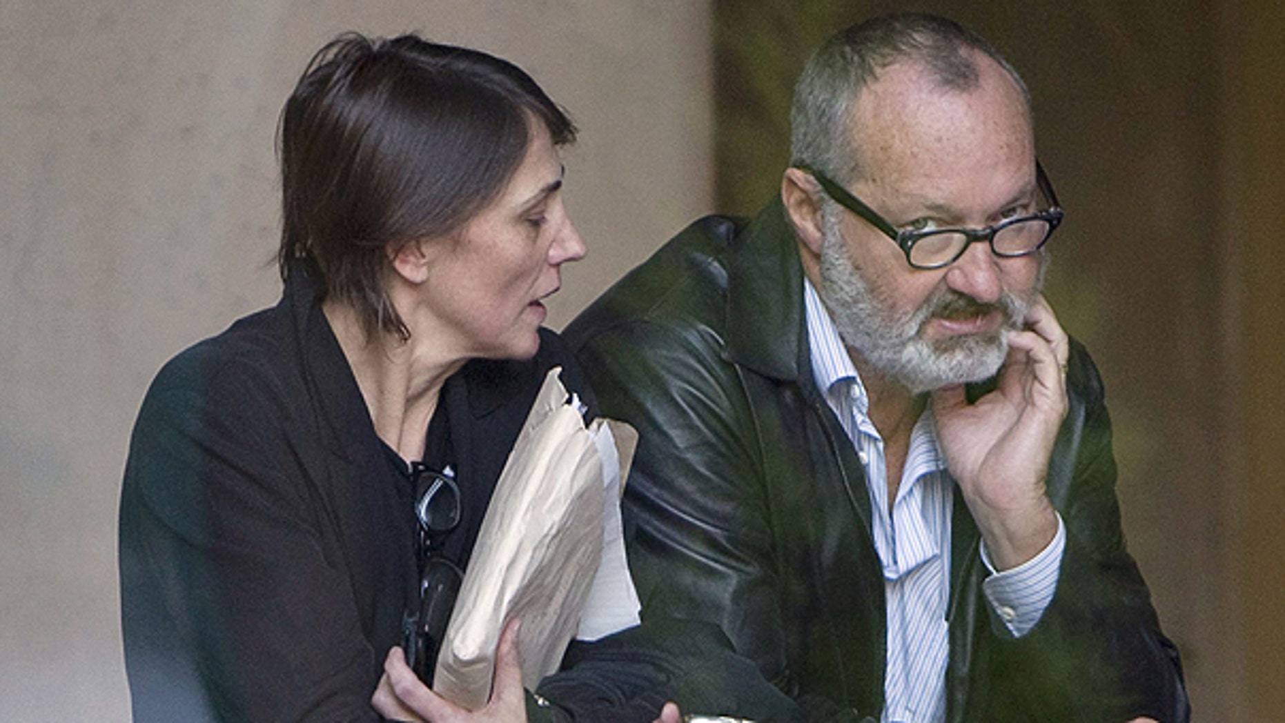 Oct. 27: Actor Randy Quaid, right, and his wife Evi wait are seen inside the building of his lawyers office in Vancouver, British Columbia, Canada.