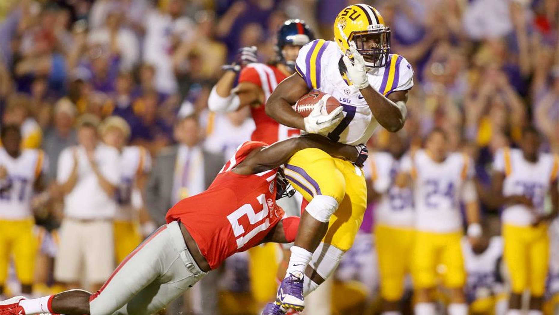 Oct 25, 2014; Baton Rouge, LA, USA; LSU Tigers running back Leonard Fournette (7) is tackled by Mississippi Rebels defensive back Senquez Golson (21) as he carries the ball in the first quarter at Tiger Stadium. Mandatory Credit: Crystal LoGiudice-USA TODAY Sports