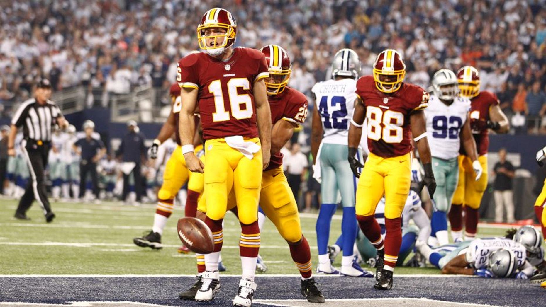 Oct 27, 2014; Arlington, TX, USA; Washington Redskins quarterback Colt McCoy (16) celebrates scoring a touchdown in the fourth quarter against the Dallas Cowboys at AT&T Stadium. Mandatory Credit: Tim Heitman-USA TODAY Sports