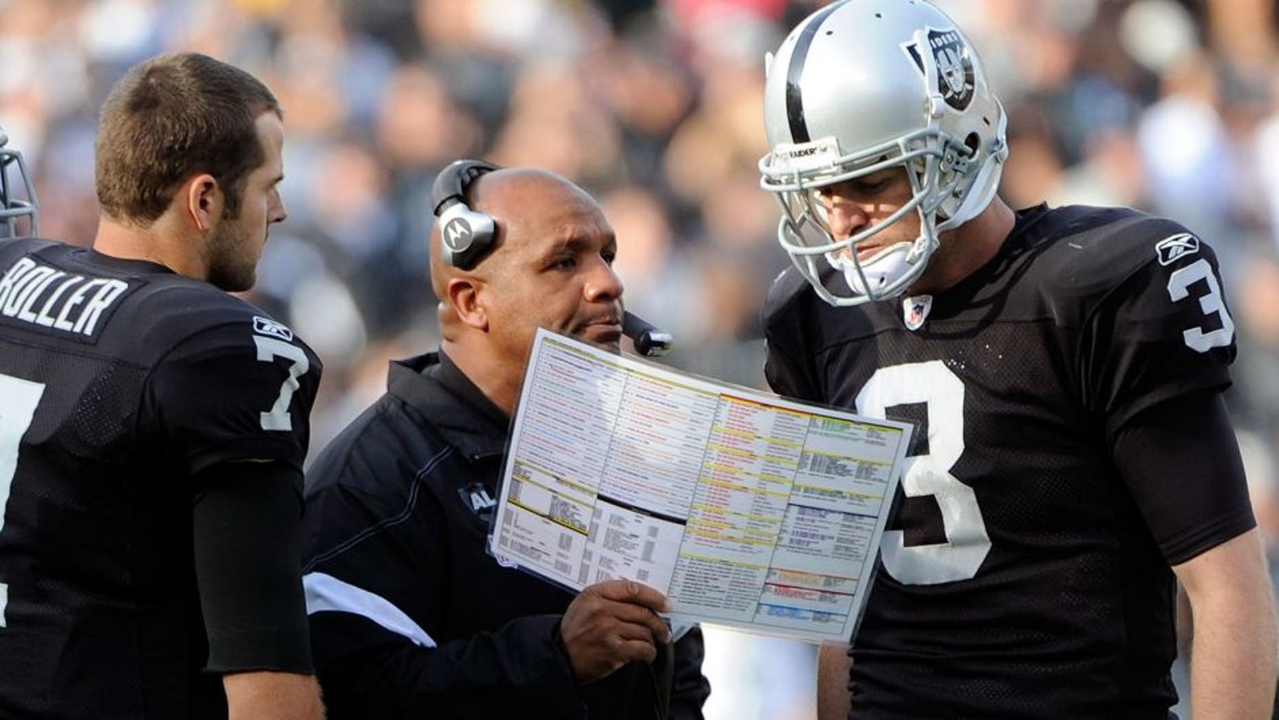 OAKLAND, CA - NOVEMBER 27: Head Coach Hue Jackson and quarterback Carson Palmer #3 of the Oakland Raiders looks over the game plan against the Chicago Bears at O.co Coliseum on November 27, 2011 in Oakland, California. The Raiders won the game 25-20. (Photo by Thearon W. Henderson/Getty Images) *** Local Caption *** Hue Jackson; Carson Palmer