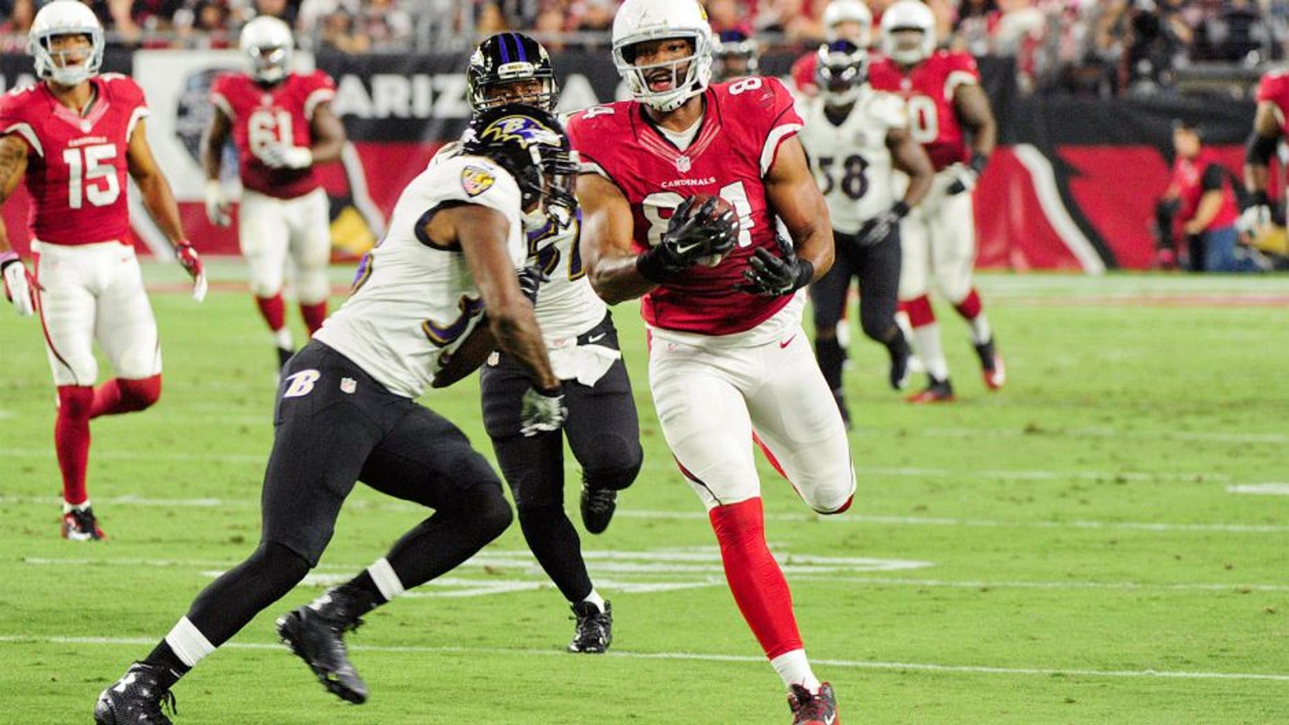 Oct 26, 2015; Glendale, AZ, USA; Baltimore Ravens strong safety Will Hill (33) hits Arizona Cardinals tight end Jermaine Gresham (84) during the first half at University of Phoenix Stadium. Mandatory Credit: Matt Kartozian-USA TODAY Sports