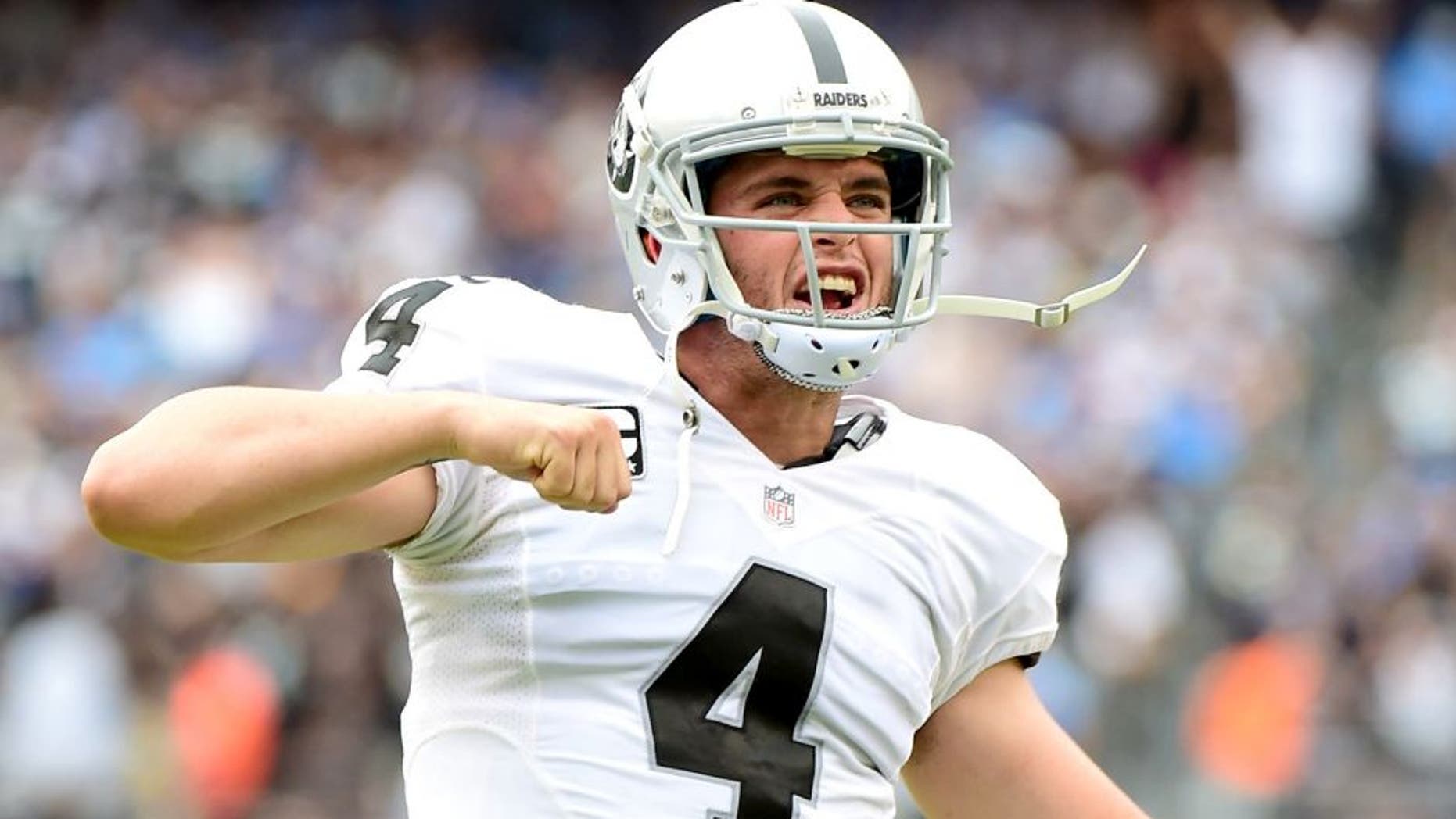 SAN DIEGO, CA - OCTOBER 25: Derek Carr #4 of the Oakland Raiders celebrates his touchdown pass to Clive Walford #88 during the second quarter against the San Diego Chargers at Qualcomm Stadium on October 25, 2015 in San Diego, California. (Photo by Harry How/Getty Images)