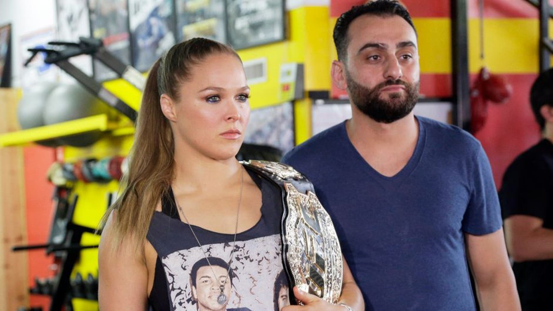UFC champion Ronda Rousey and her coach Edmond Tarverdyan are seen at a promotional appearance for Rouseyâs next title defense in Glendale, Calif., Tuesday, Oct. 27, 2015. Rousey isnât sharing her opinion of her motherâs sharp criticism of her coach. Tarverdyan also declined to criticize AnnMaria De Mars. Rousey (12-0) will attempt her seventh title defense when she faces former boxing champion Holly Holm at UFC 193 in Melbourne, Australia, on Nov. 15. She has won her previous three fights in 64 combined seconds, establishing herself as the UFCâs most dominant champion and the worldâs most famous MMA fighter.(AP Photo/Nick Ut)