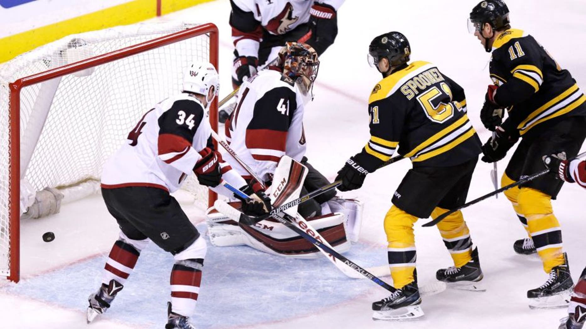Boston Bruins right wing Jimmy Hayes (11) scores on Arizona Coyotes goalie Mike Smith (41) during the second period of an NHL hockey game in Boston, Tuesday, Oct. 27, 2015. (AP Photo/Charles Krupa)