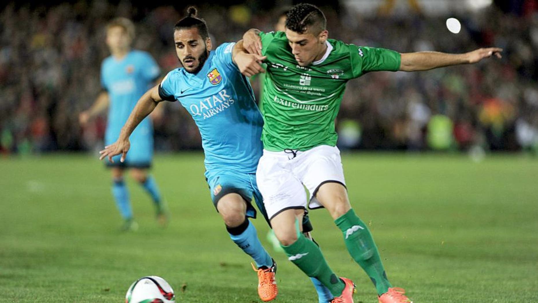 Barcelona's Brazilian defender Douglas (L) vies with Villanovense's defender Tapia (R) during the Spanish Copa del Rey (King's Cup) Round of 32 first leg football match CF Villanovense vs FC Barcelona at the Romero Cuerda stadium in Villanueva de la Serena on October 28, 2015. AFP PHOTO / CRISTINA QUICLER (Photo credit should read CRISTINA QUICLER/AFP/Getty Images)