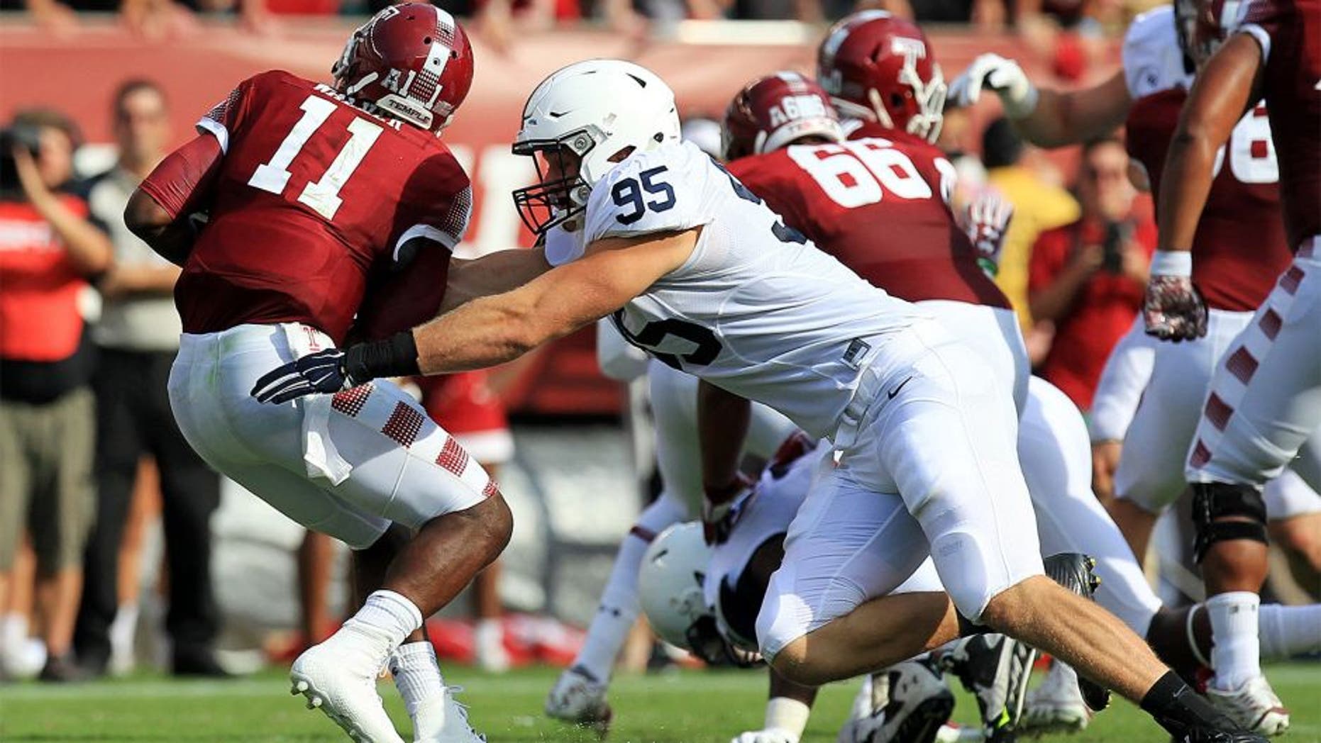 Sep 5, 2015; Philadelphia, PA, USA; Penn State Nittany Lions defensive end Carl Nassib (95) sacks Temple Owls quarterback P.J. Walker (11) during the second quarter at Lincoln Financial Field. Mandatory Credit: Matthew O'Haren-USA TODAY Sports