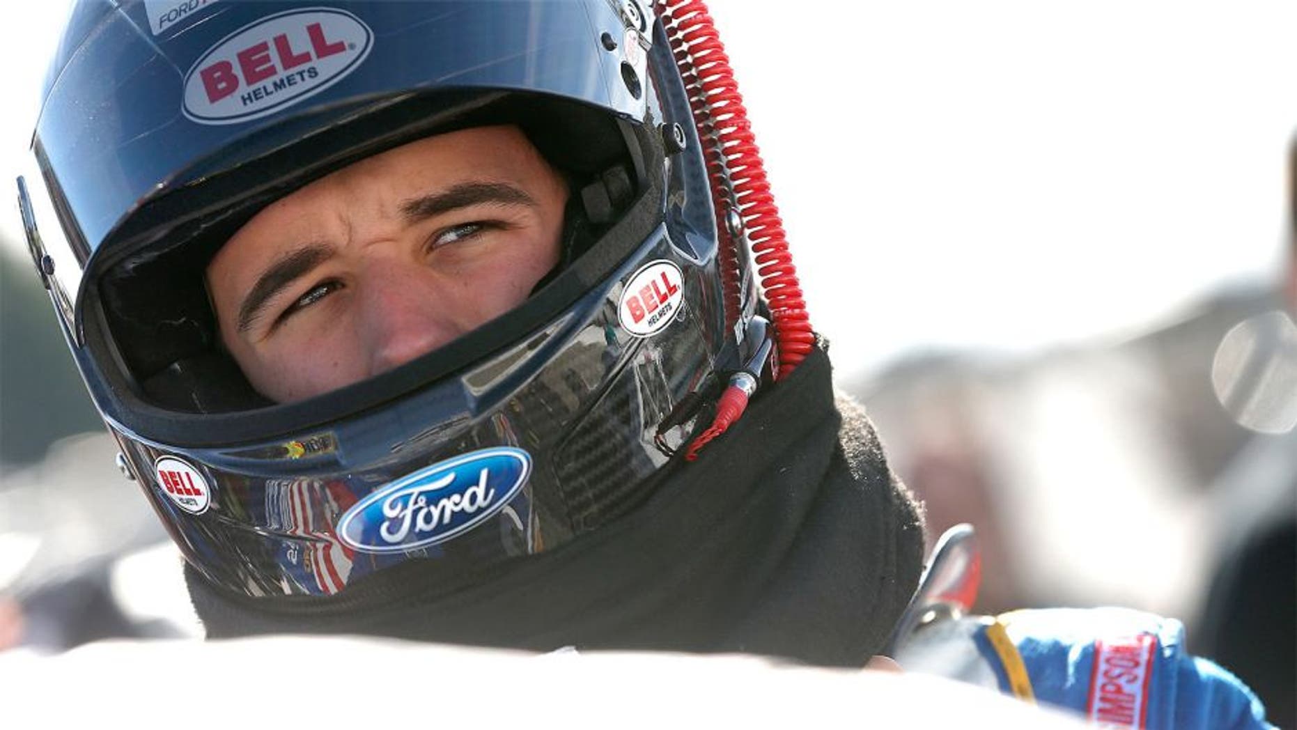 LOUDON, NH - SEPTEMBER 26: Austin Theriault, driver of the #29 Cooper Standard Ford, stands on the grid during qualifying for the NASCAR Camping World Truck Series UNOH 175 at New Hampshire Motor Speedway on September 26, 2015 in Loudon, New Hampshire. (Photo by Brian Lawdermilk/NASCAR via Getty Images)