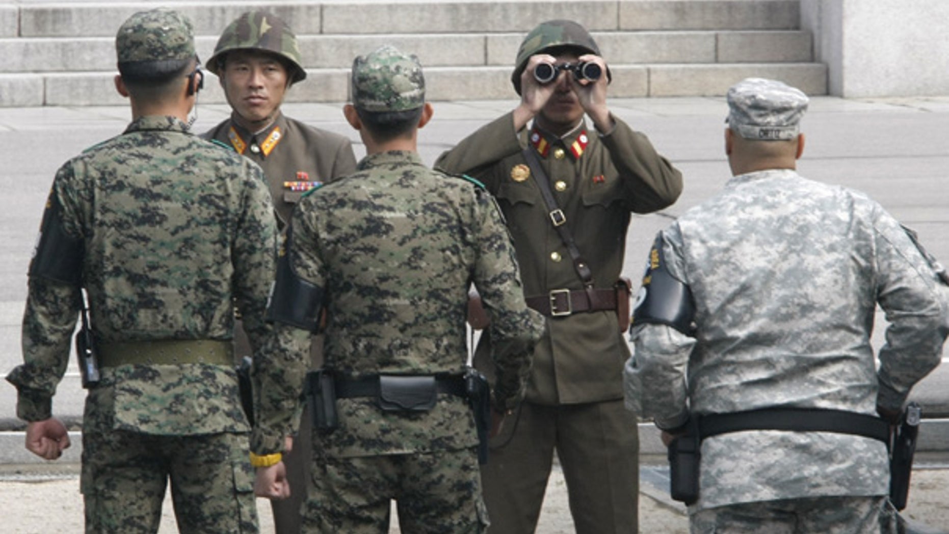 Oct. 20: North Korean soldiers look across the border as South Korean and U.S. Army soldiers stand guard.