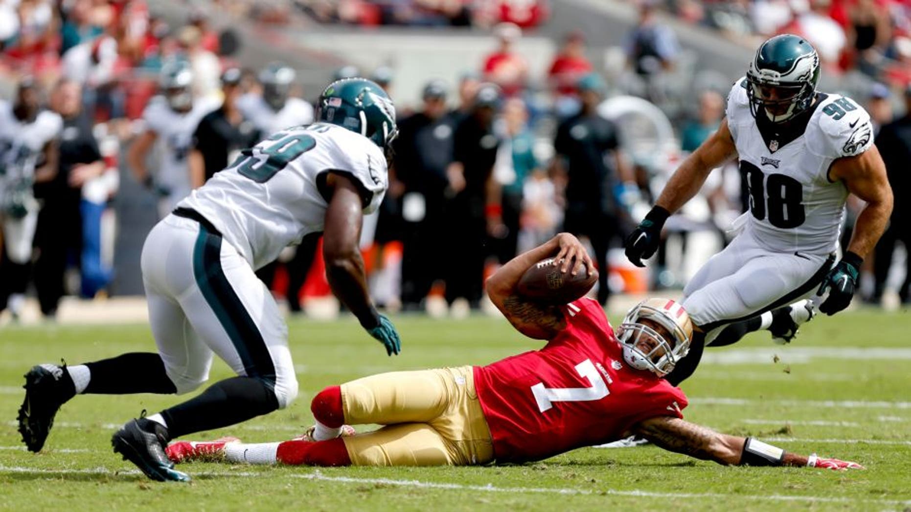 Sep 28, 2014; Santa Clara, CA, USA; San Francisco 49ers quarterback Colin Kaepernick (7) slides on the play against Philadelphia Eagles inside linebacker DeMeco Ryans (59) and outside linebacker Connor Barwin (98) during the first quarter at Levi's Stadium. Mandatory Credit: Kelley L Cox-USA TODAY Sports
