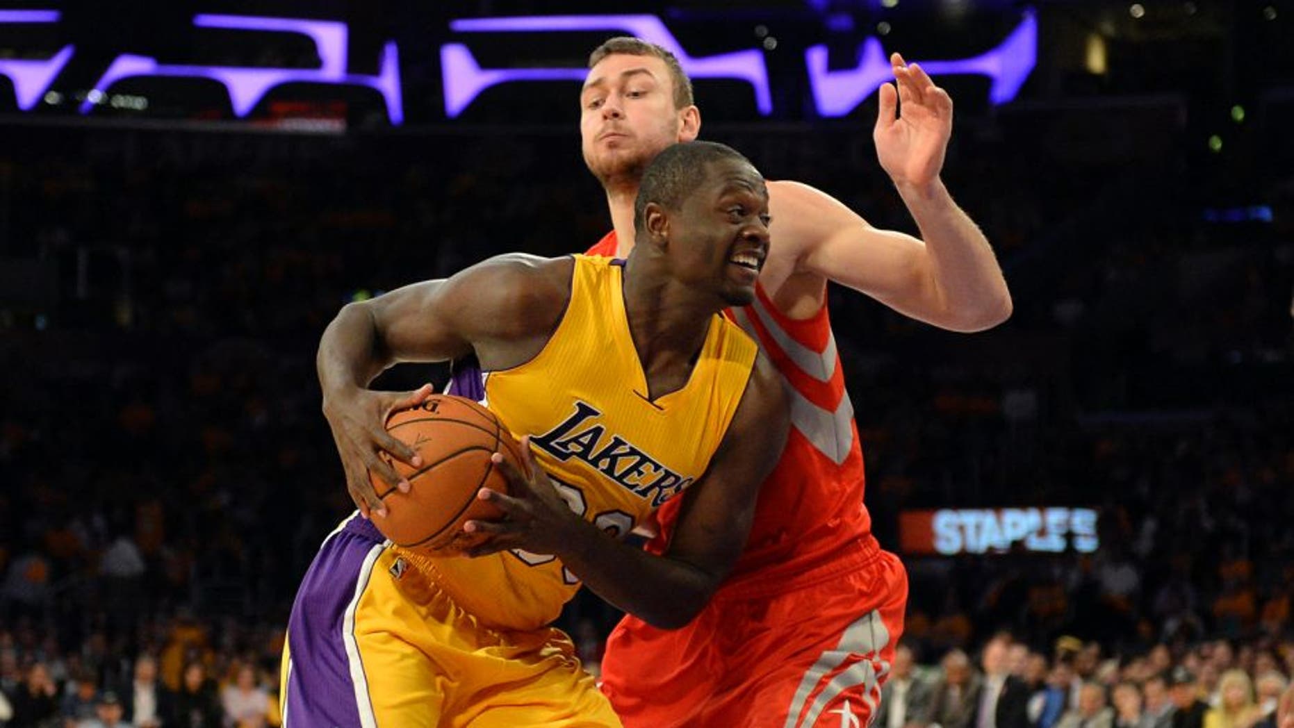 Oct 28, 2014; Los Angeles, CA, USA; Los Angeles Lakers forward Julius Randle (30) drives against Houston Rockets forward Donatas Motiejunas (20) during the second half at Staples Center. Mandatory Credit: Richard Mackson-USA TODAY Sports