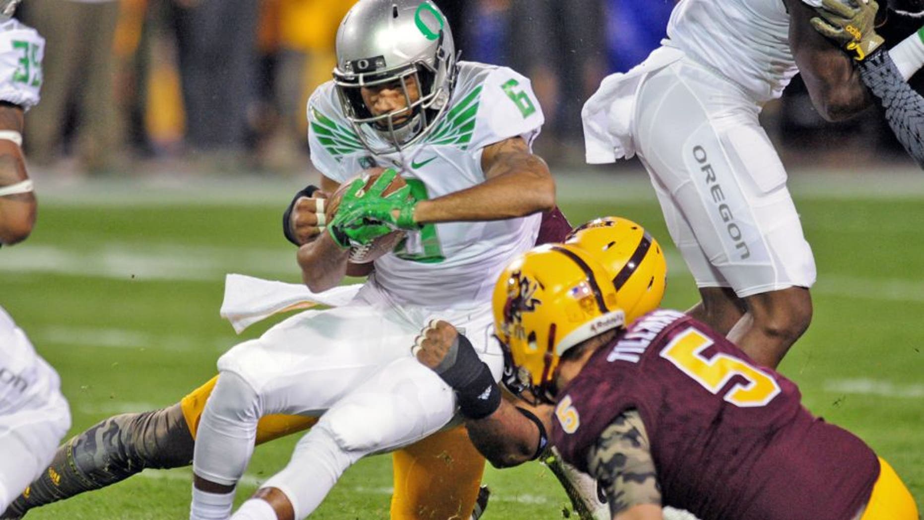 Oct 29, 2015; Tempe, AZ, USA; Oregon Ducks wide receiver Charles Nelson (6) is tackled by Arizona State Sun Devils linebacker Ismael Murphy-Richardson (17) and defensive back Chad Adams (5) during the first half at Sun Devil Stadium. Mandatory Credit: Matt Kartozian-USA TODAY Sports