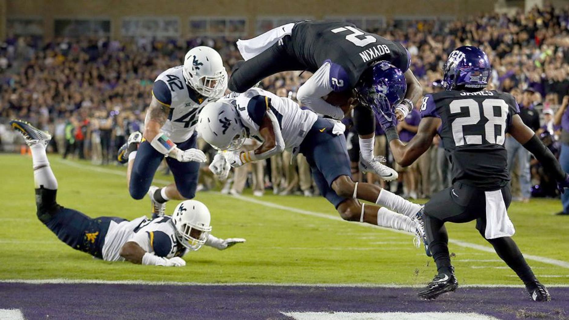 FORT WORTH, TX - OCTOBER 29: Trevone Boykin #2 of the TCU Horned Frogs scores a touchdown against Daryl Worley #7 of the West Virginia Mountaineers in the first quarter at Amon G. Carter Stadium on October 29, 2015 in Fort Worth, Texas. (Photo by Tom Pennington/Getty Images)
