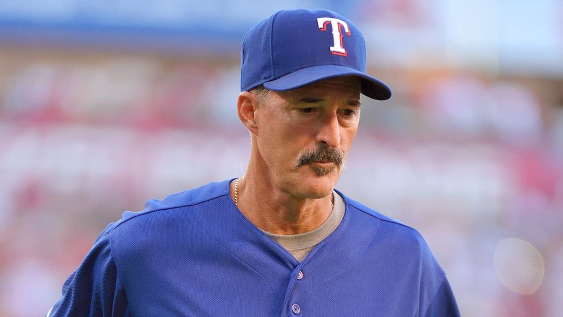 ANAHEIM, CA - JULY 25: Pitching coach Mike Maddux #31 of the Texas Rangers returns to the dugout after a visit to the mound during the second inning of the game against the Los Angeles Angels of Anaheim at Angel Stadium of Anaheim on July 25, 2015 in Anaheim, California. (Photo by Matt Brown/Angels Baseball LP/Getty Images)