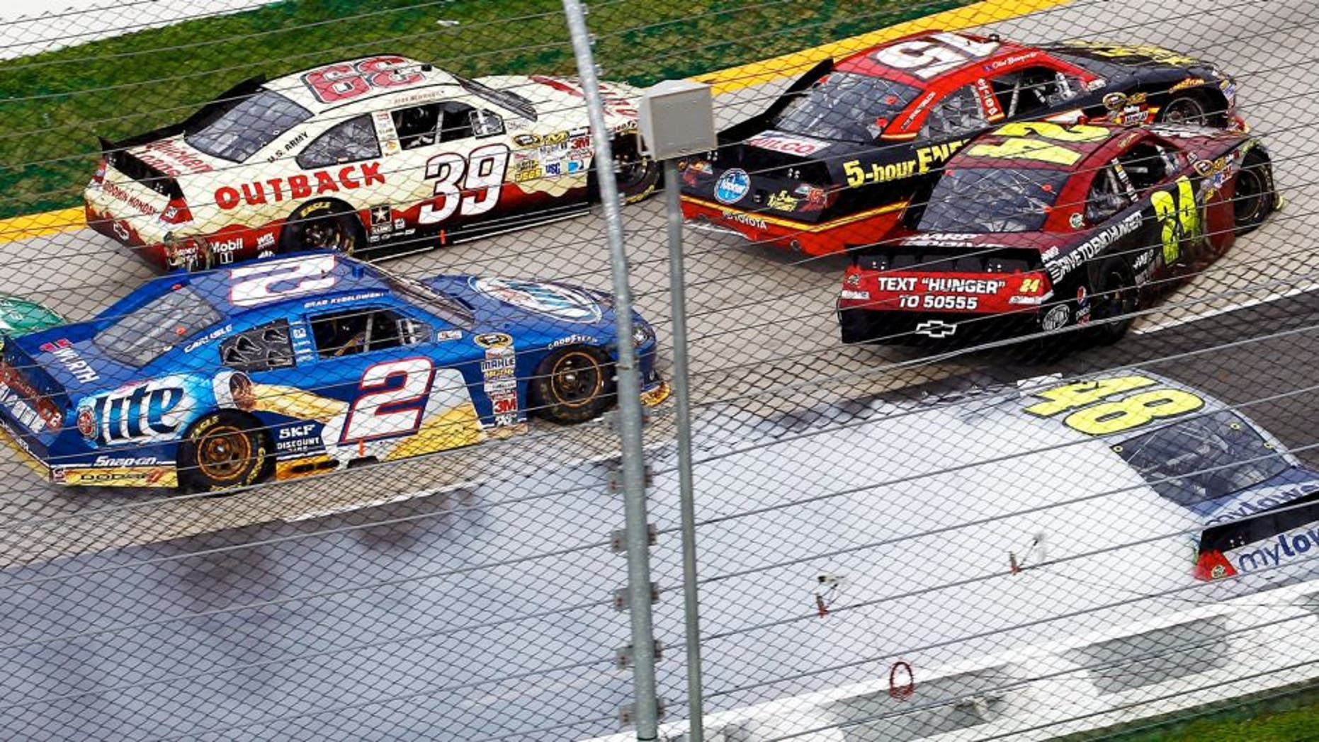 Ryan Newman, driver of the #39 Outback Steak House Chevrolet, steers low to avoid the incident between Clint Bowyer, driver of the #15 5-hour Energy Toyota, Jimmie Johnson, driver of the #48 MyLowe's Chevrolet, , Jeff Gordon, driver of the #24 Drive to End Hunger Chevrolet, and Brad Keselowski, driver of the #2 Miller Lite Dodge, in turn two during the NASCAR Sprint Cup Series Goody's Fast Relief 500 at Martinsville Speedway on April 1, 2012 in Martinsville, Virginia. (Photo by Jeff Zelevansky/Getty Images)