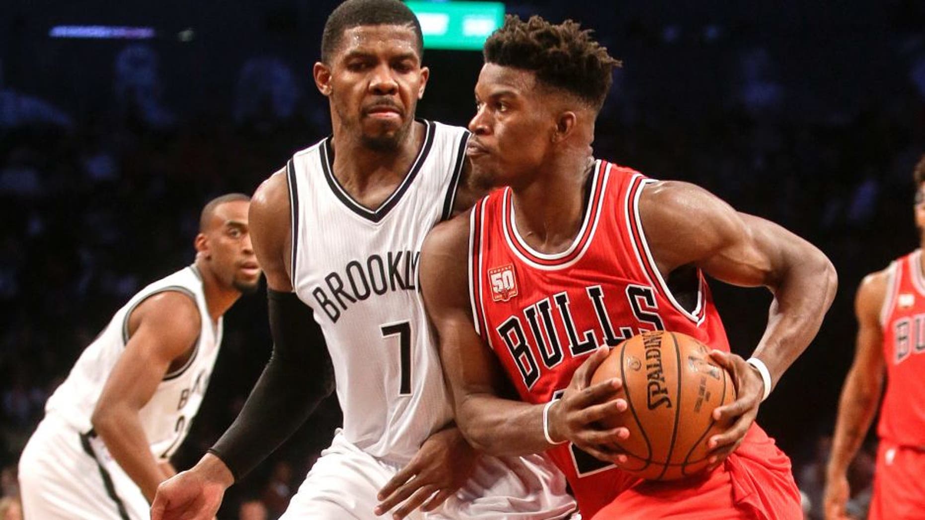 Brooklyn Nets' Joe Johnson (7) defends Chicago Bulls' Jimmy Butler (21) during the second half of an NBA basketball game Wednesday, Oct. 28, 2015, in New York. The Bulls won 115-100. (AP Photo/Frank Franklin II)