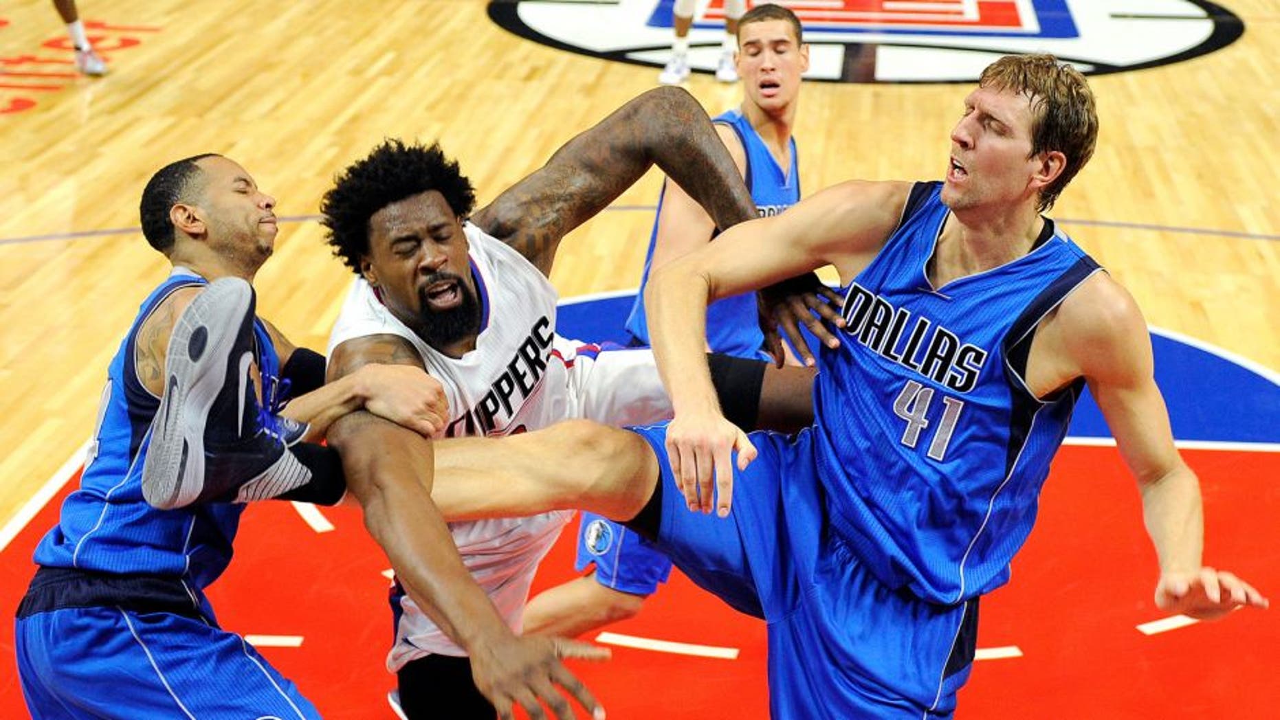 LOS ANGELES CA - OCTOBER 29: DeAndre Jordan #6 of the Los Angeles Clippers is fouled by Dirk Nowitzki #41 and Devin Harris of the Dallas Mavericks during the second quarter of the basketball game Staples Center October 29, 2015, in Los Angeles California. (Photo by Kevork Djansezian/Getty Images)