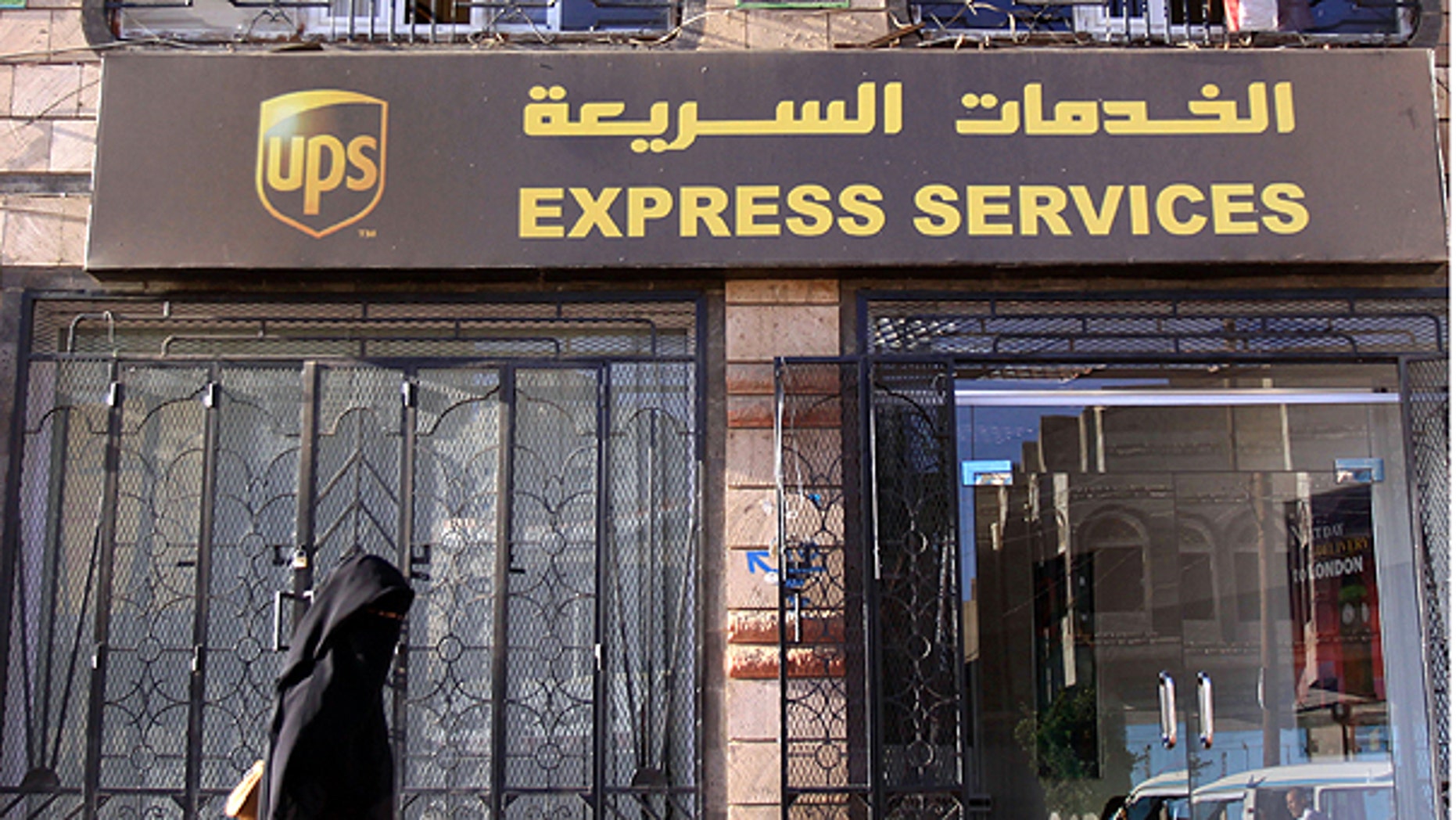 Oct. 30: An unidentified Yemeni woman walks past UPS office in San'a, Yemen.