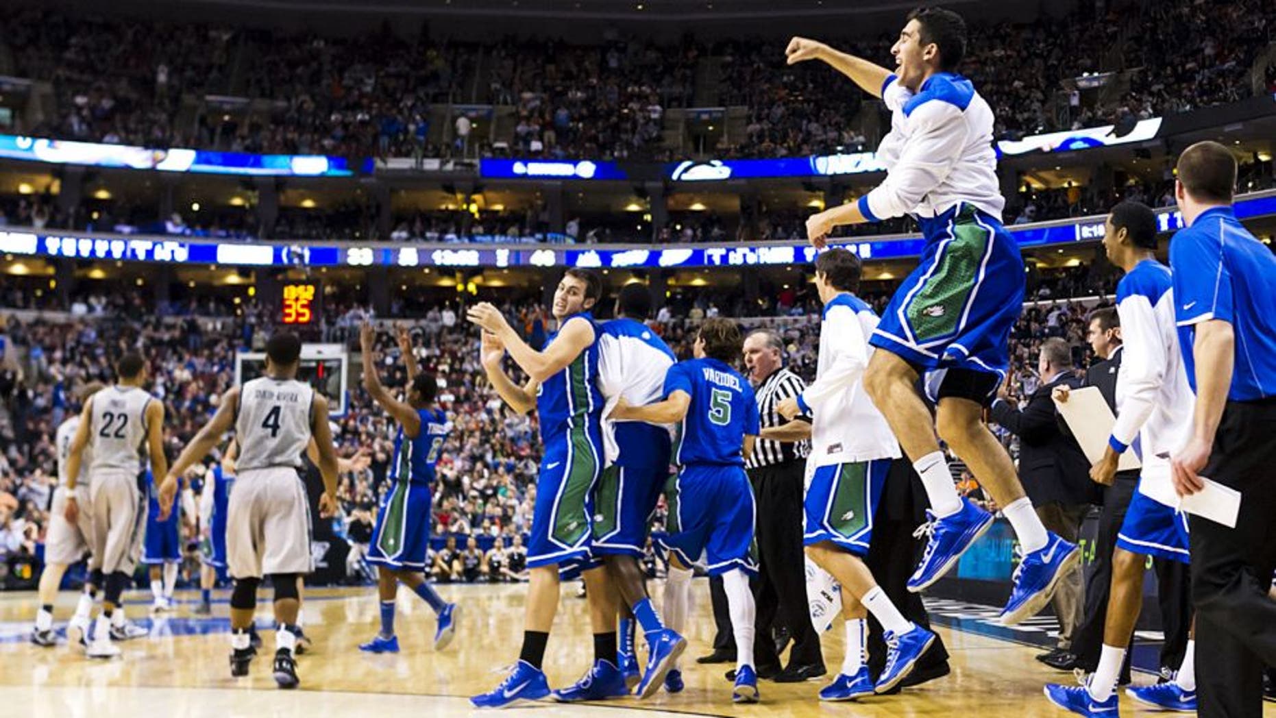 Mar 22, 2013; Philadelphia, PA, USA; Florida Gulf Coast Eagles players celebrate ;ate in the second half against the Georgetown Hoyas during the second round of the 2013 NCAA tournament at the Wells Fargo Center. Florida Gulf Coast defeated Georgetown 78-68. Mandatory Credit: Howard Smith-USA TODAY Sports