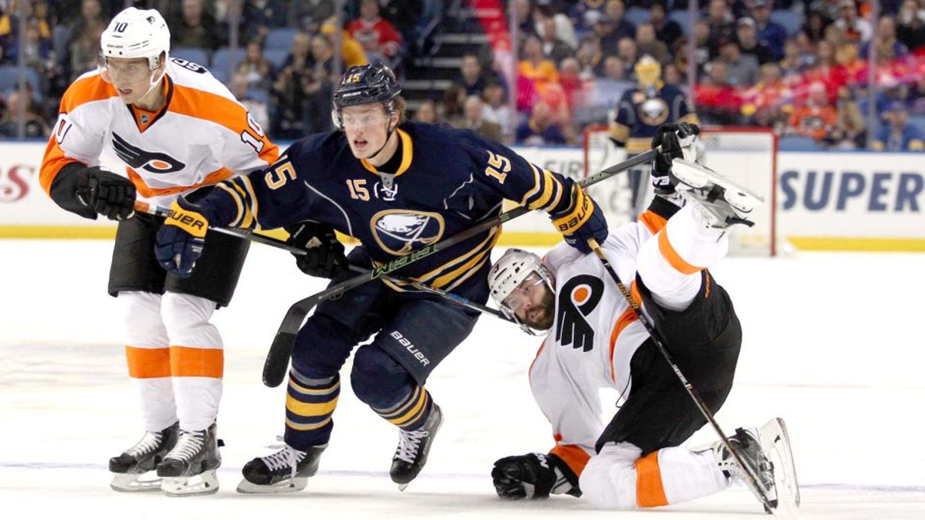 Oct 30, 2015; Buffalo, NY, USA; Buffalo Sabres center Jack Eichel (15) goes after a loose puck while being defended by Philadelphia Flyers center Brayden Schenn (10) and defenseman Radko Gudas (3) during the second period at First Niagara Center. Mandatory Credit: Timothy T. Ludwig-USA TODAY Sports