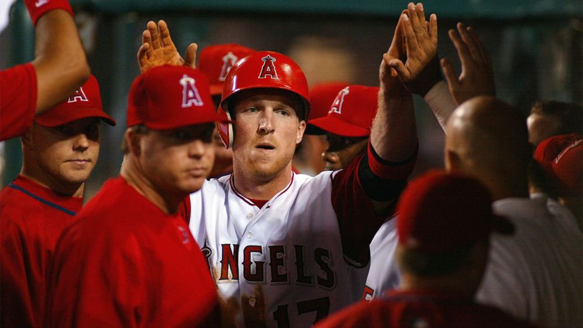 ANAHEIM, CA- AUGUST 03: Darin Erstad of the Anaheim Angels high fives his teammates after scoring his team's third run on a Tim Salmon double against the New York Yankees, at Edison International Field on August 3, 2002 in Anaheim, California.(Photo by Robert Laberge/Getty Images).