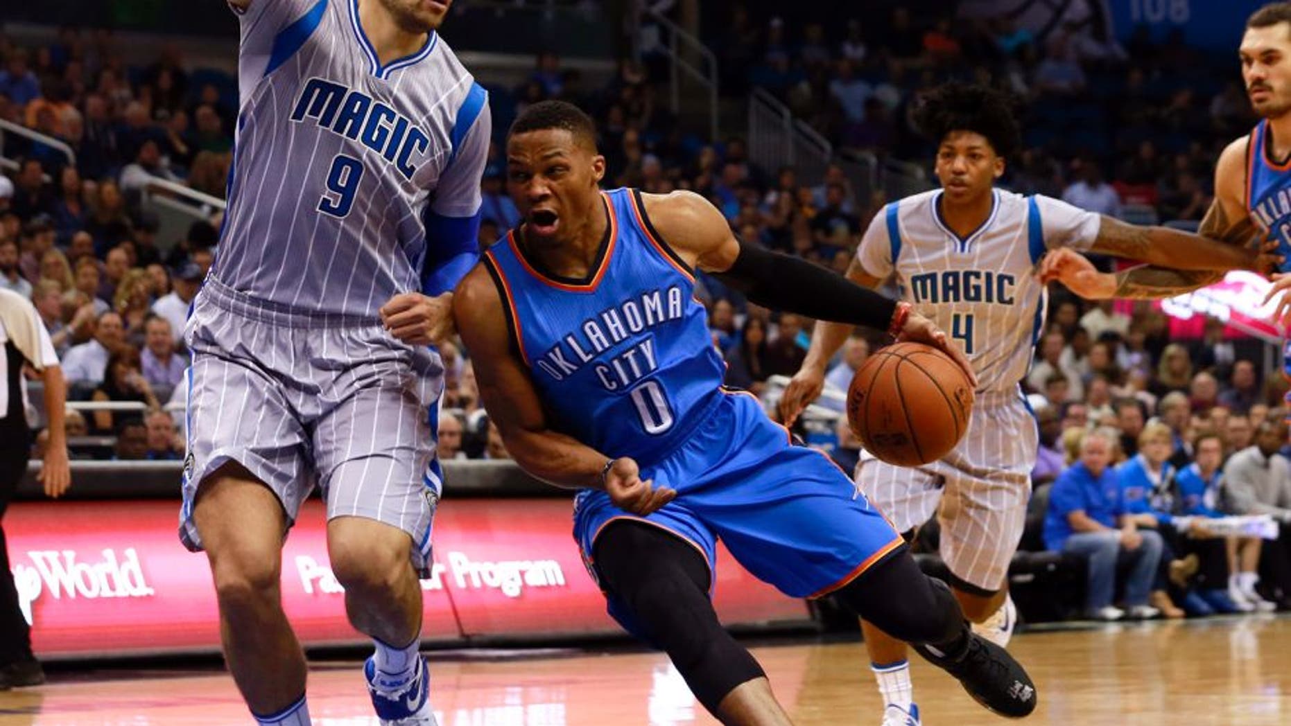 Oct 30, 2015; Orlando, FL, USA; Oklahoma City Thunder guard Russell Westbrook (0) drives to the basket as Orlando Magic center Nikola Vucevic (9) defends during the first quarter at Amway Center. Mandatory Credit: Kim Klement-USA TODAY Sports