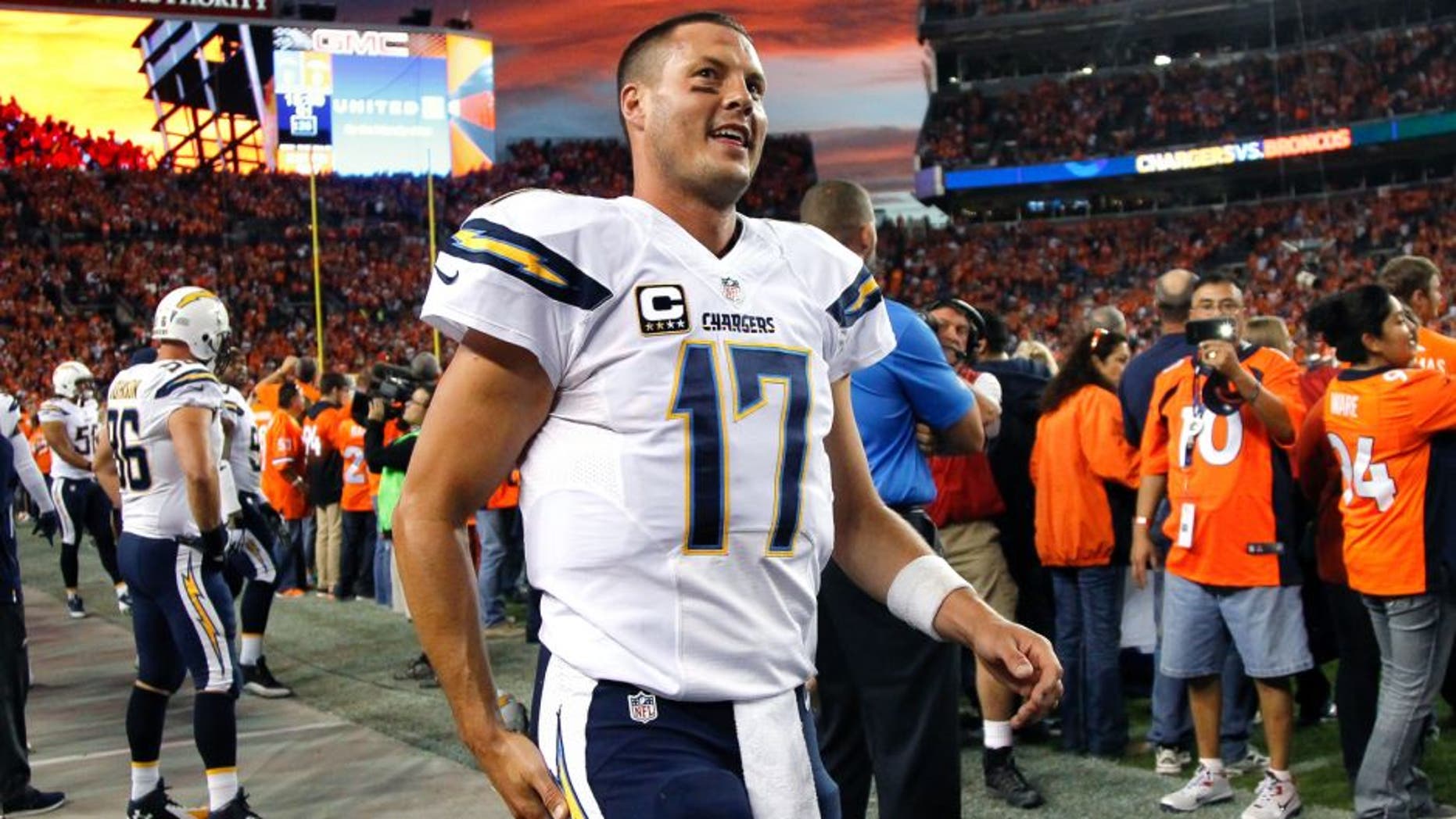 DENVER, CO - OCTOBER 23: Quarterback Philip Rivers #17 of the San Diego Chargers jogs along the sideline before the start of a game against the Denver Broncos at Sports Authority Field at Mile High on October 23, 2014 in Denver, Colorado. (Photo by Doug Pensinger/Getty Images)
