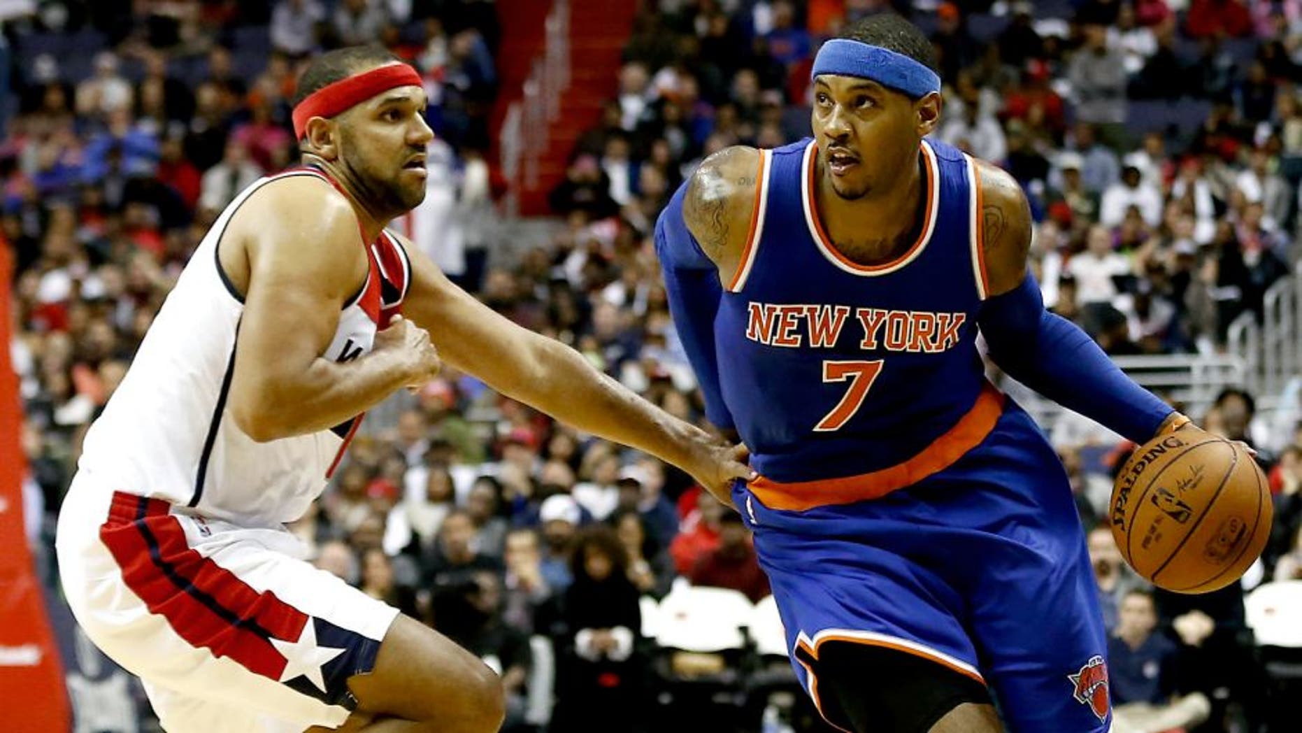 Oct 31, 2015; Washington, DC, USA; New York Knicks forward Carmelo Anthony (7) dribbles the ball as Washington Wizards guard Jared Dudley (1) defends in the fourth quarter at Verizon Center. The Knicks won 113-110. Mandatory Credit: Geoff Burke-USA TODAY Sports