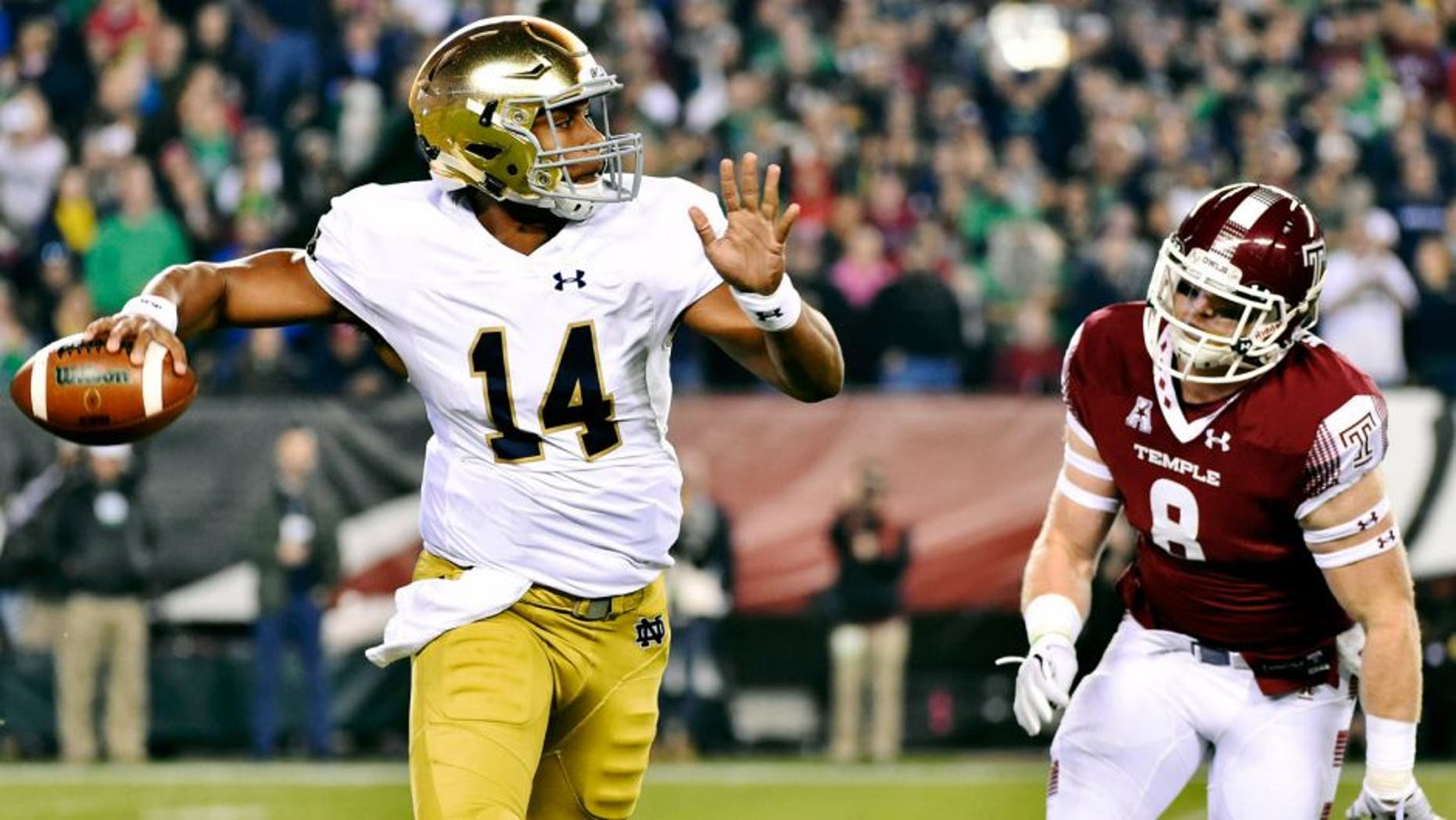 Oct 31, 2015; Philadelphia, PA, USA; Notre Dame Fighting Irish quarterback DeShone Kizer (14) is chased by Temple Owls linebacker Tyler Matakevich (8) during the first quarter at Lincoln Financial Field. Mandatory Credit: Derik Hamilton-USA TODAY Sports