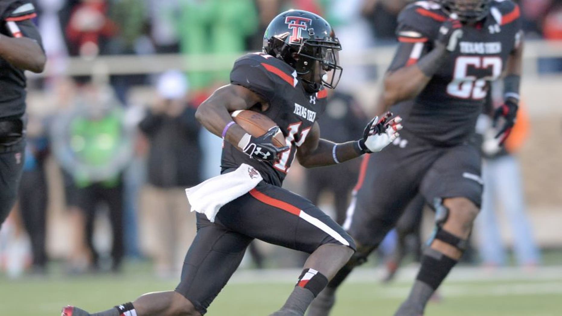 LUBBOCK, TX - NOVEMBER 2: Jakeem Grant #11 of the Texas Tech Red Raiders rushes the ball during game action against the Oklahoma State Cowboys on November 2, 2013 at AT&T Jones Stadium in Lubbock, Texas. Oklahoma State won the game 52-34 (Photo by John Weast/Getty Images)