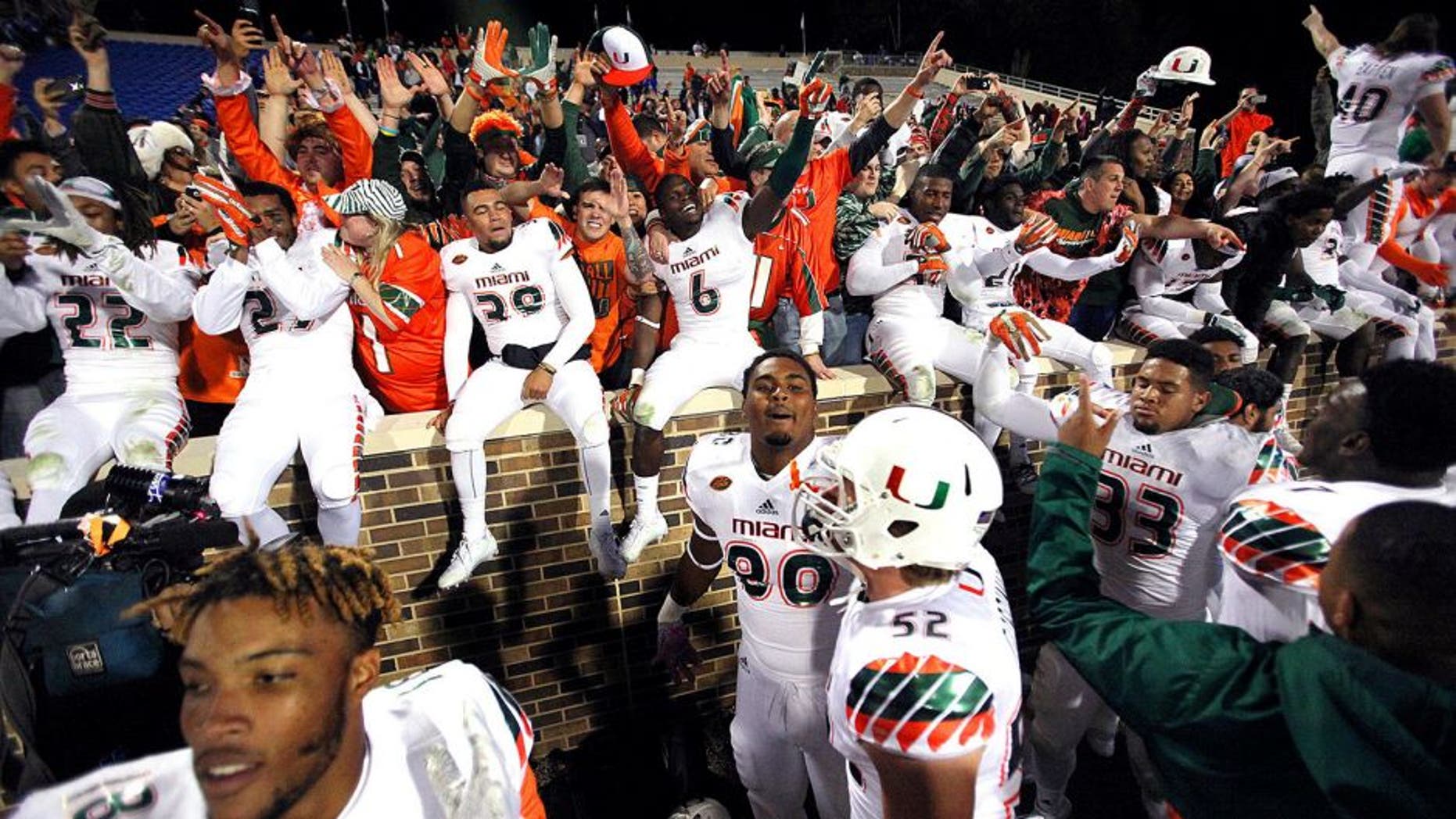 Oct 31, 2015; Durham, NC, USA; The Miami Hurricanes celebrate with their fans after beating the Duke Blue Devils 30-27 at Wallace Wade Stadium. Mandatory Credit: Mark Dolejs-USA TODAY Sports