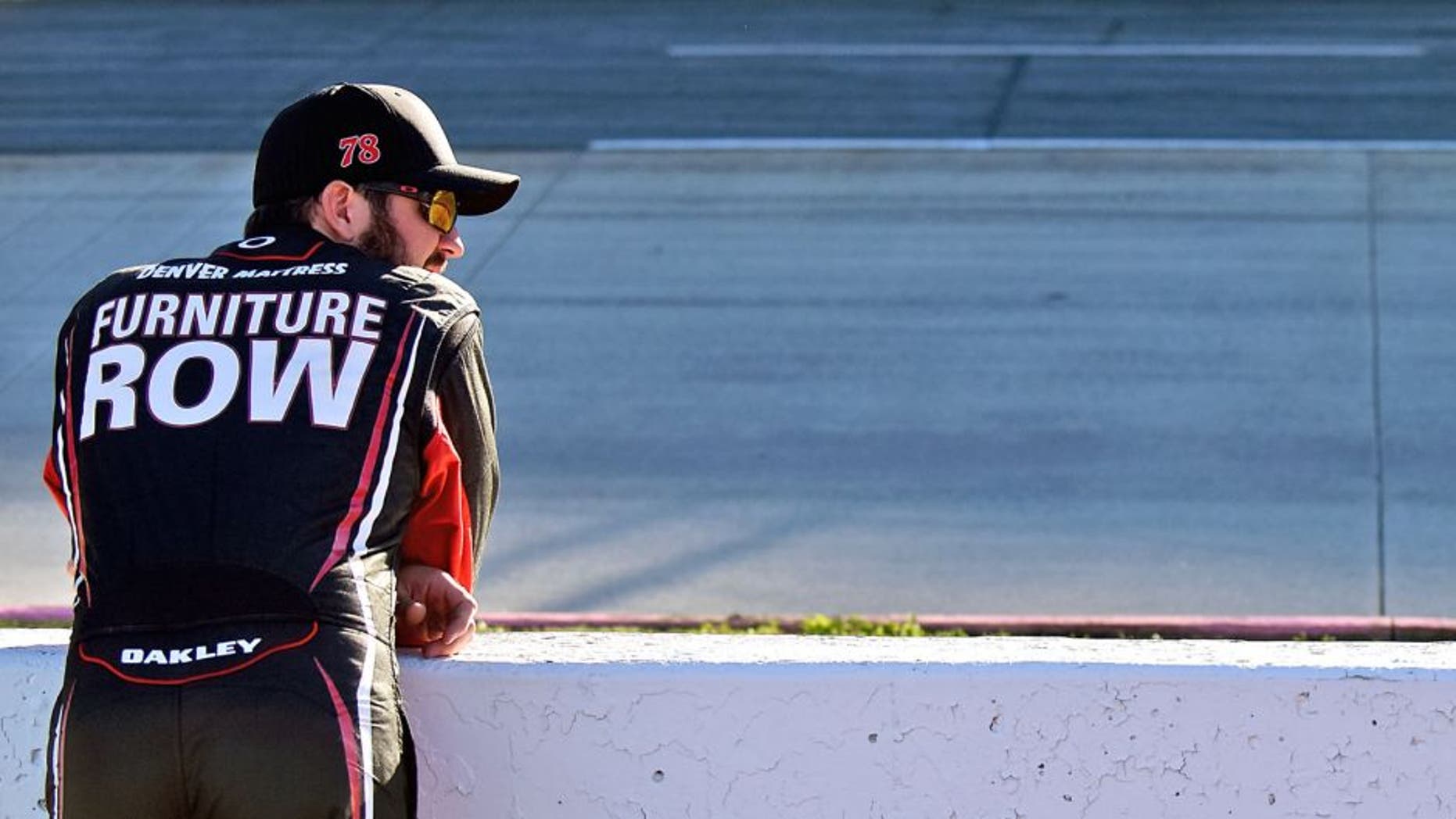 MARTINSVILLE, VA - OCTOBER 30: Martin Truex Jr., driver of the #78 Furniture Row/Visser Precision Chevrolet, stands on the grid during qualifying for the NASCAR Sprint Cup Series Goody's Headache Relief Shot 500 at Martinsville Speedway on October 30, 2015 in Martinsville, Virginia. (Photo by Jonathan Moore/Getty Images)
