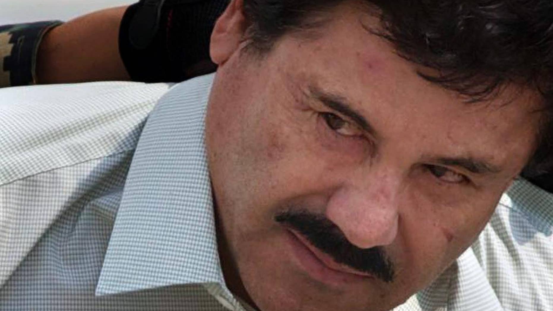 FILE - In this Feb. 22, 2014, file photo, Joaquin "El Chapo" Guzman is escorted to a helicopter by Mexican navy marines in Mexico City, Mexico. The normally bucolic, vacationer-laden Mexican state at the tip of Baja peninsula is now the scene of dozens of killings in what authorities call a power struggle resulting from the February arrest of international drug lord Joaquin “El Chapo” Guzman. (AP Photo/Eduardo Verdugo, File)
