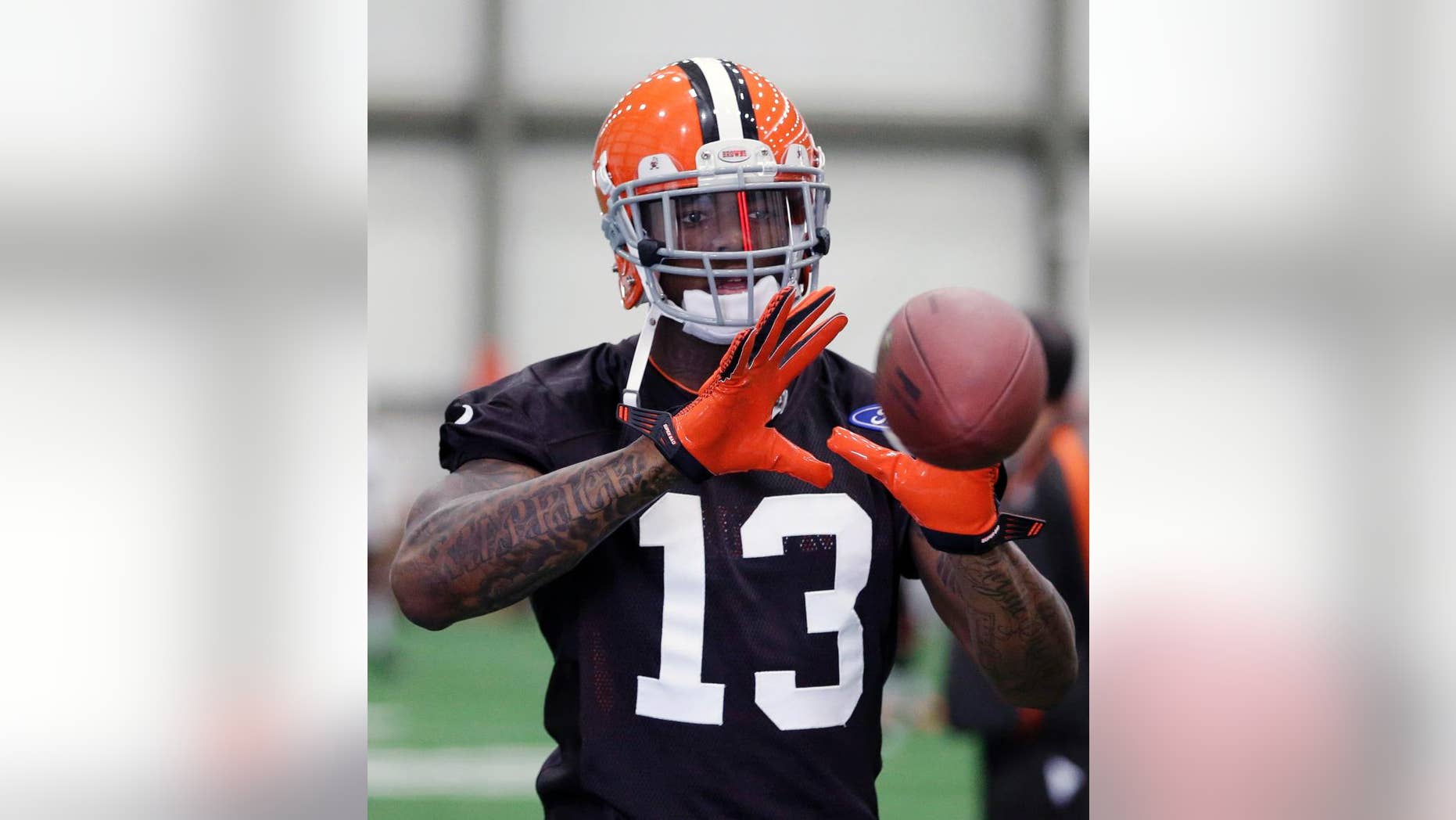FILE - In this April 17, 2013, file photo, Cleveland Browns wide receiver Josh Gordon catches a pass during an NFL football practice in Berea, Ohio. Player representatives to the union voted to implement HGH testing for the 2014 NFL season, Friday, Sept. 12, 2014. Overall changes are retroactive for players who are suspended under previous policies, and for those in the appeal process. Those players, presumably including Browns receiver Josh Gordon, who is suspended for the season, and Broncos receiver Wes Welker (four games), would be subject to standards of the new policies. (AP Photo/Tony Dejak, File)