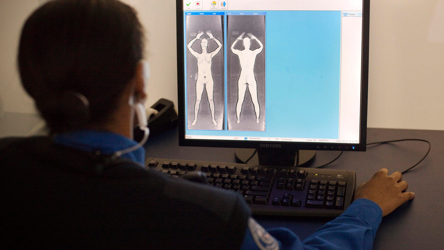 NEW YORK - OCTOBER 22: A TSA officer demonstrates what the images form the Advanced Imaging Technology unit look like at John F. Kennedy International Airport's Terminal 8 passenger security checkpoint on October 22, 2010 in the Queens borough of New York City. The new backscatter X-ray full-body scanners, which are optional, can see through clothing and will screen passengers for metallic and non-metallic threats including explosives. (Photo by Michael Nagle/Getty Images)